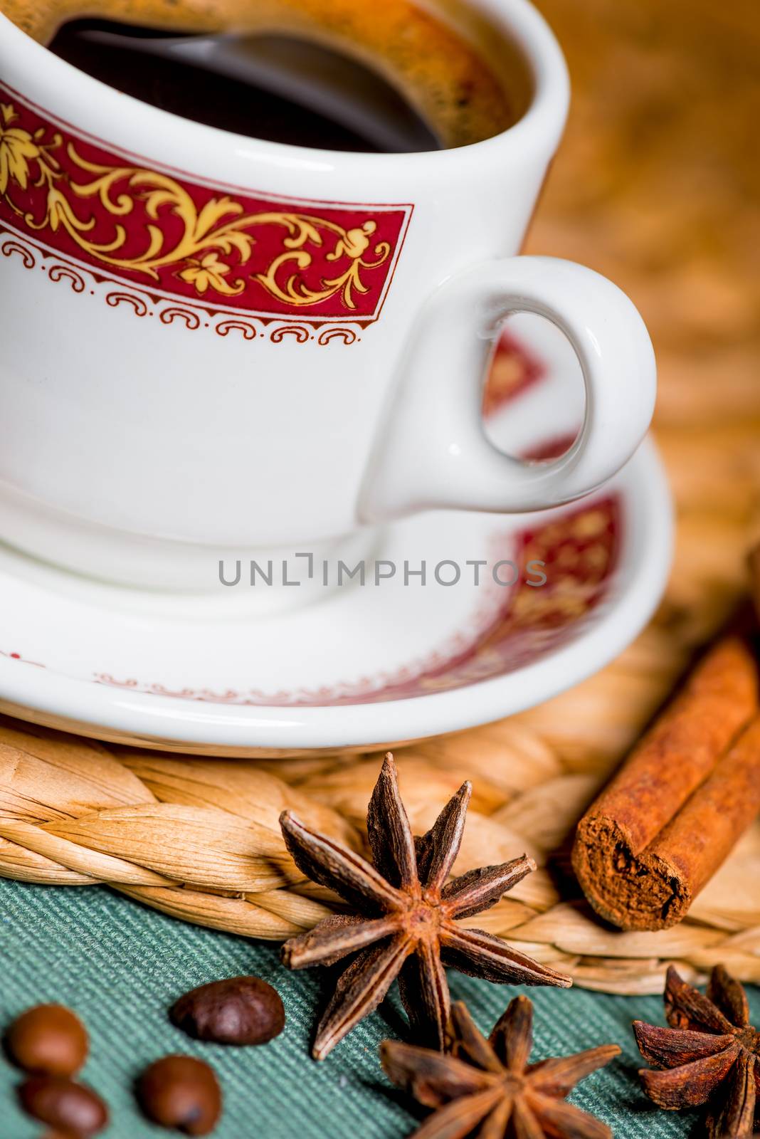 vertical still life delicious coffee in a beautiful cup with spices of cinnamon and anise