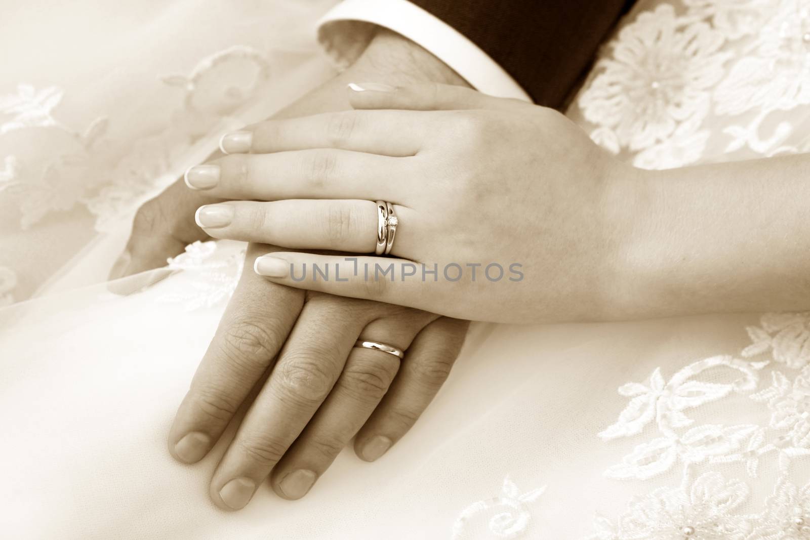 Hand of the groom and the bride with wedding rings by friday