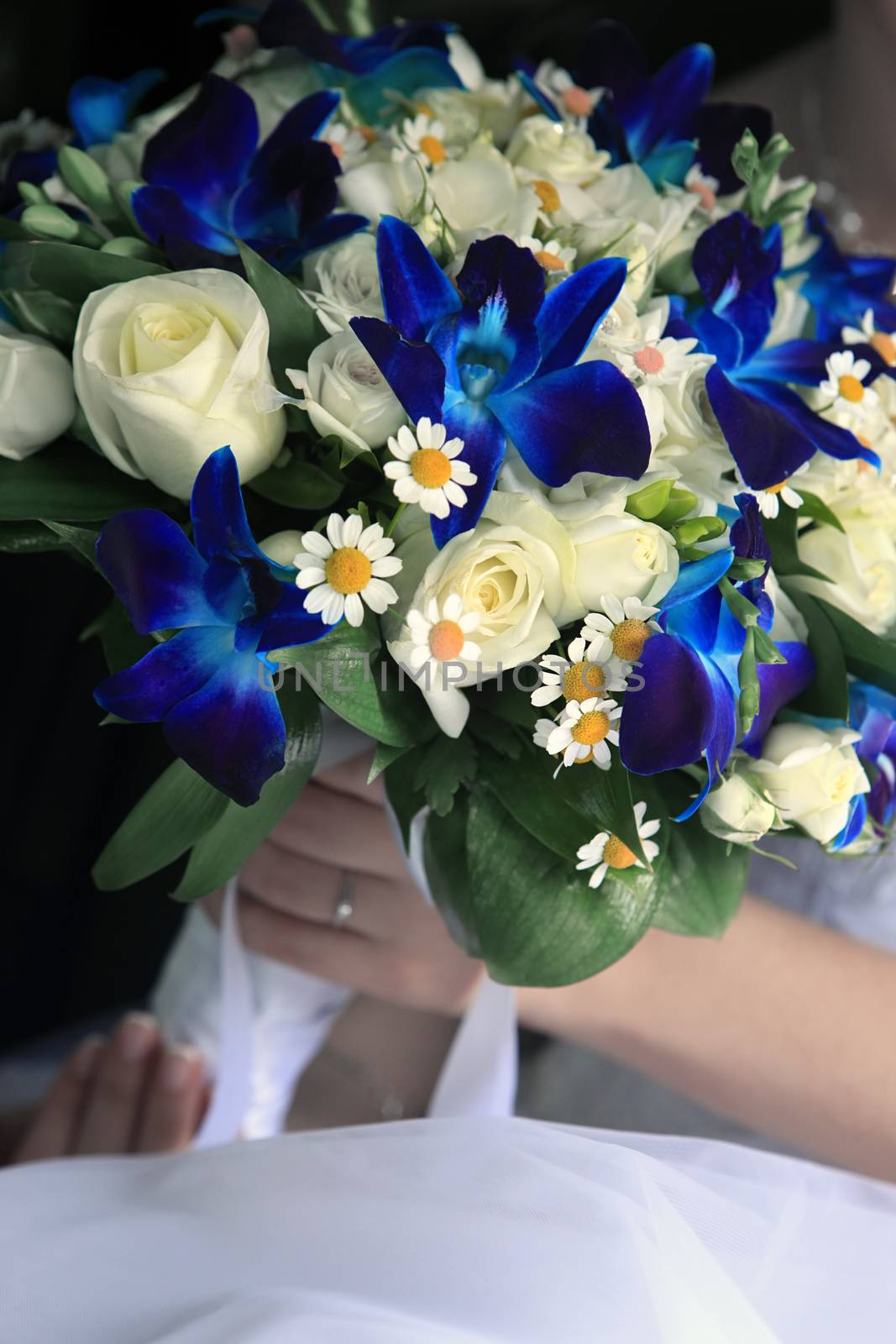 The bride holds a wedding bouquet