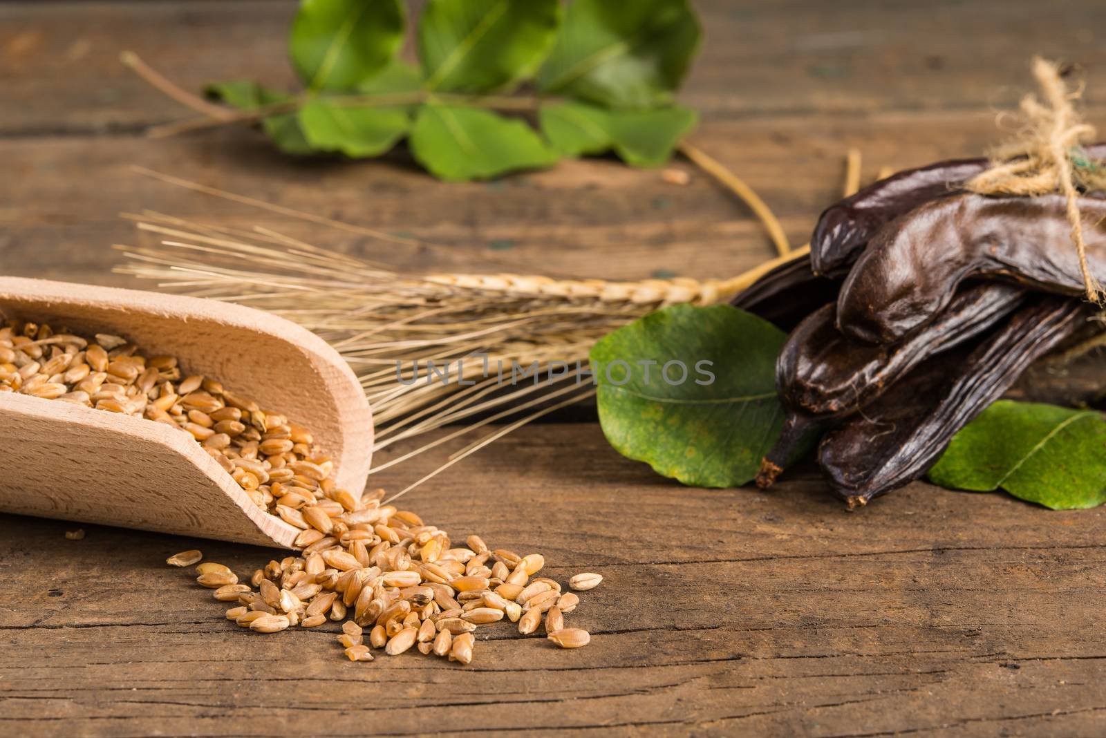 Raw fruits Carob on old wooden background
