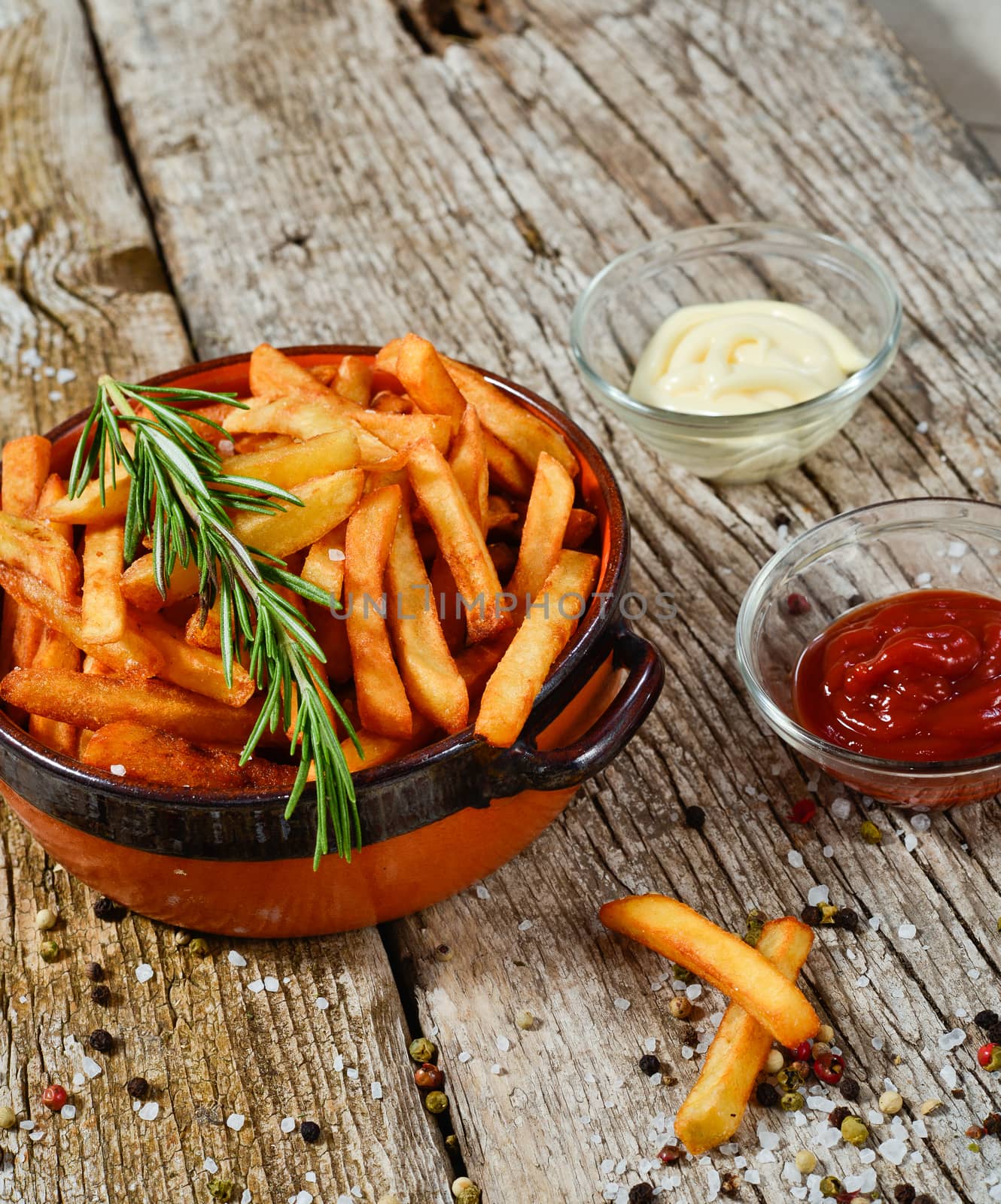 bowl of chips with salt and pepper on a wooden rustic.