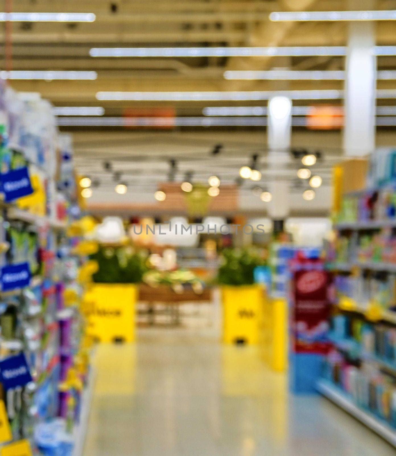 Blurred section at retail store in Europe. Aisle in local supermarket, defocused background by roman_nerud