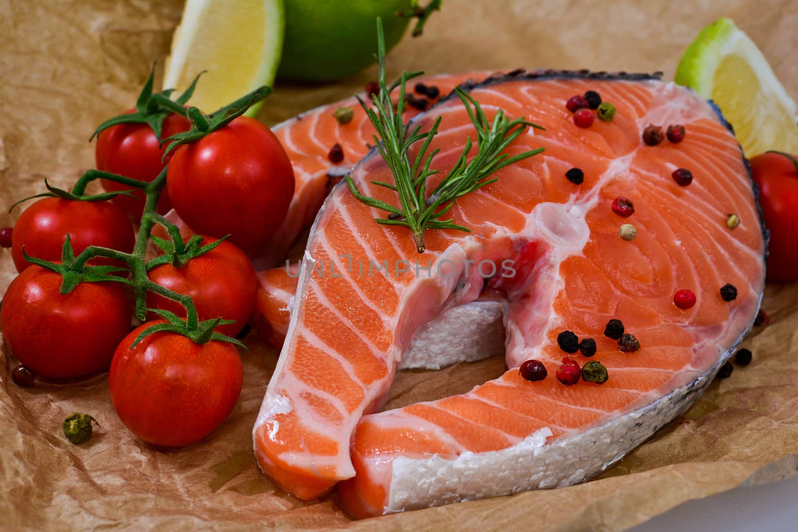 fresh salmon with rosemary, tomatoes, pepper and lemon