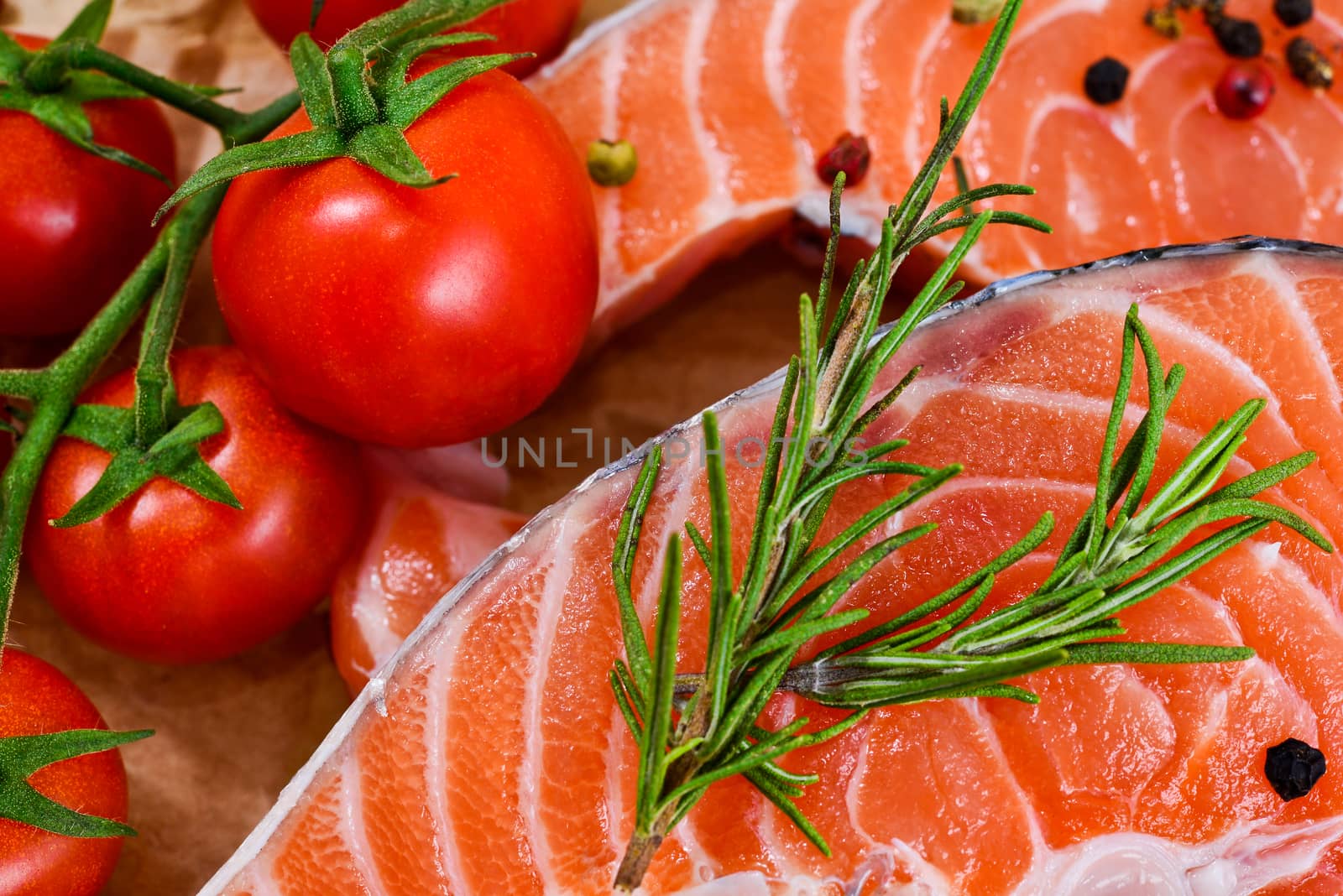fresh salmon with rosemary, tomatoes, pepper and lemon