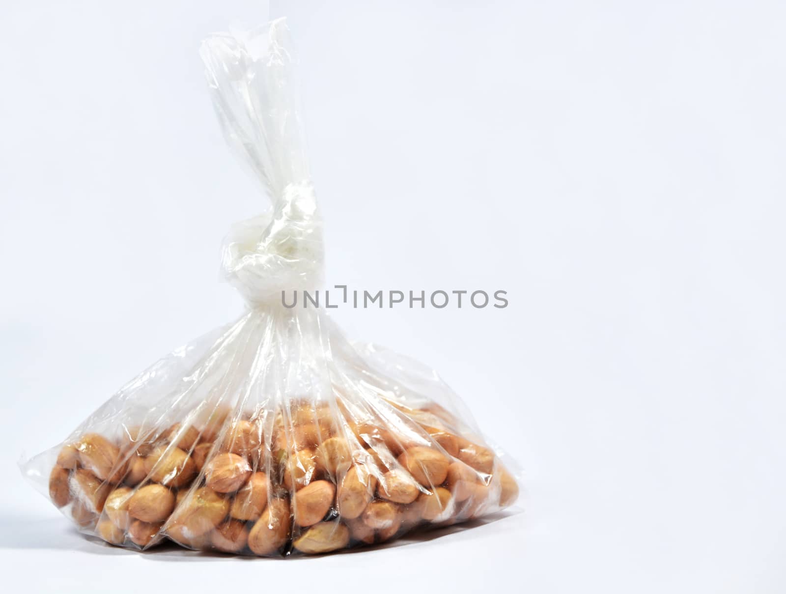 Raw Arachis hypogaea,peanut or groundnuts in a bag on isolated white background. by lakshmiprasad.maski@gmai.com