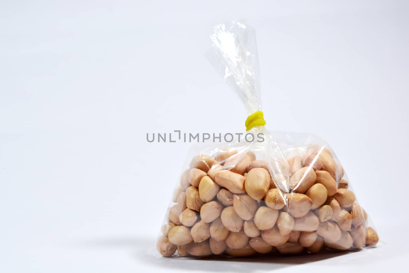 Raw Arachis hypogaea,peanut or groundnuts in a bag on isolated white background. by lakshmiprasad.maski@gmai.com