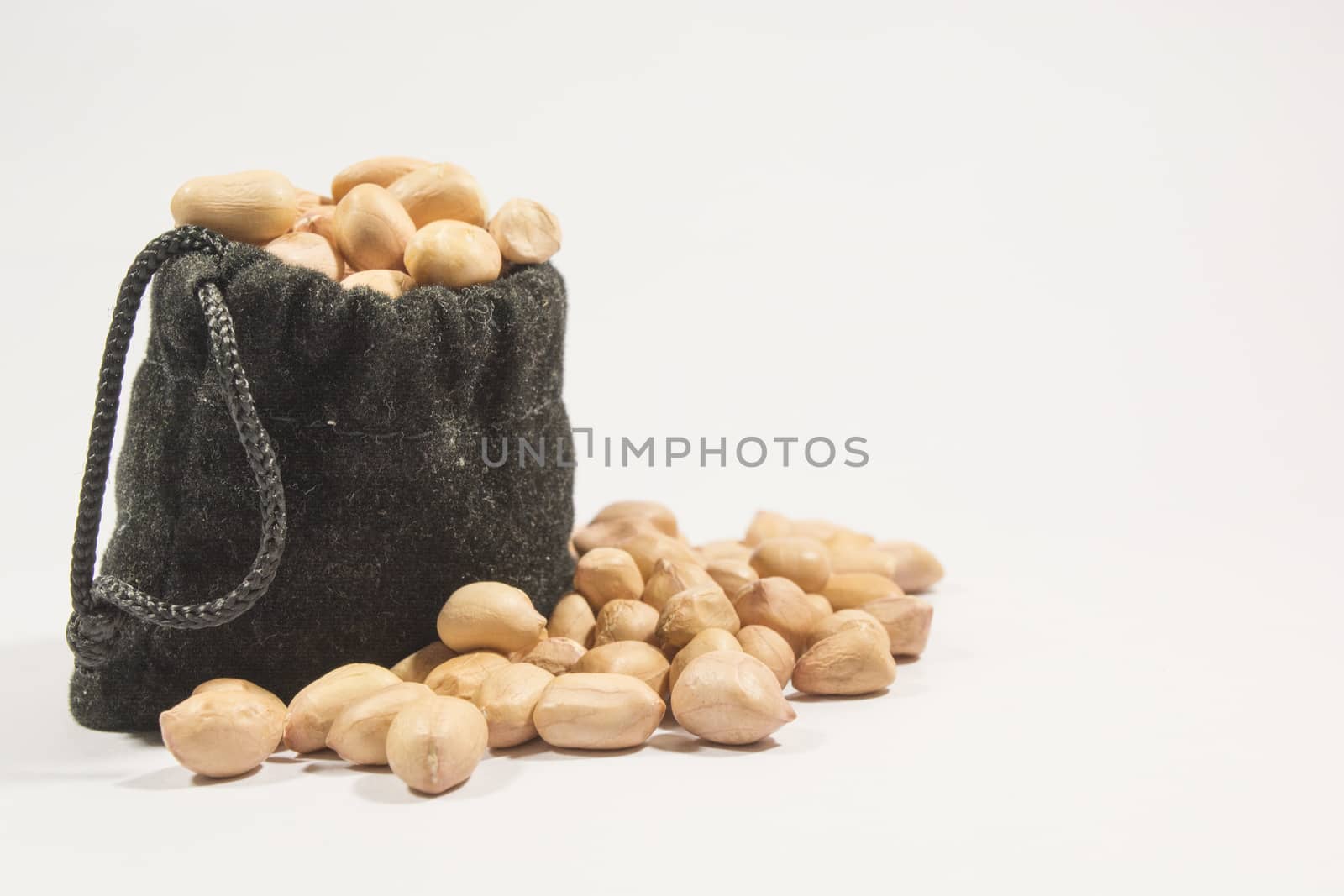 Peanuts in burlap bag isolated on white background.
