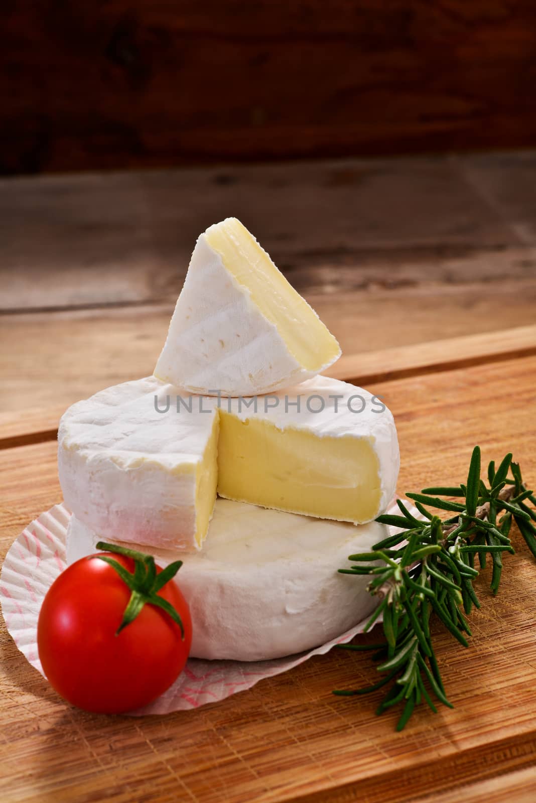 Italian tomino cheese on a wooden chopping board, italian appetizer