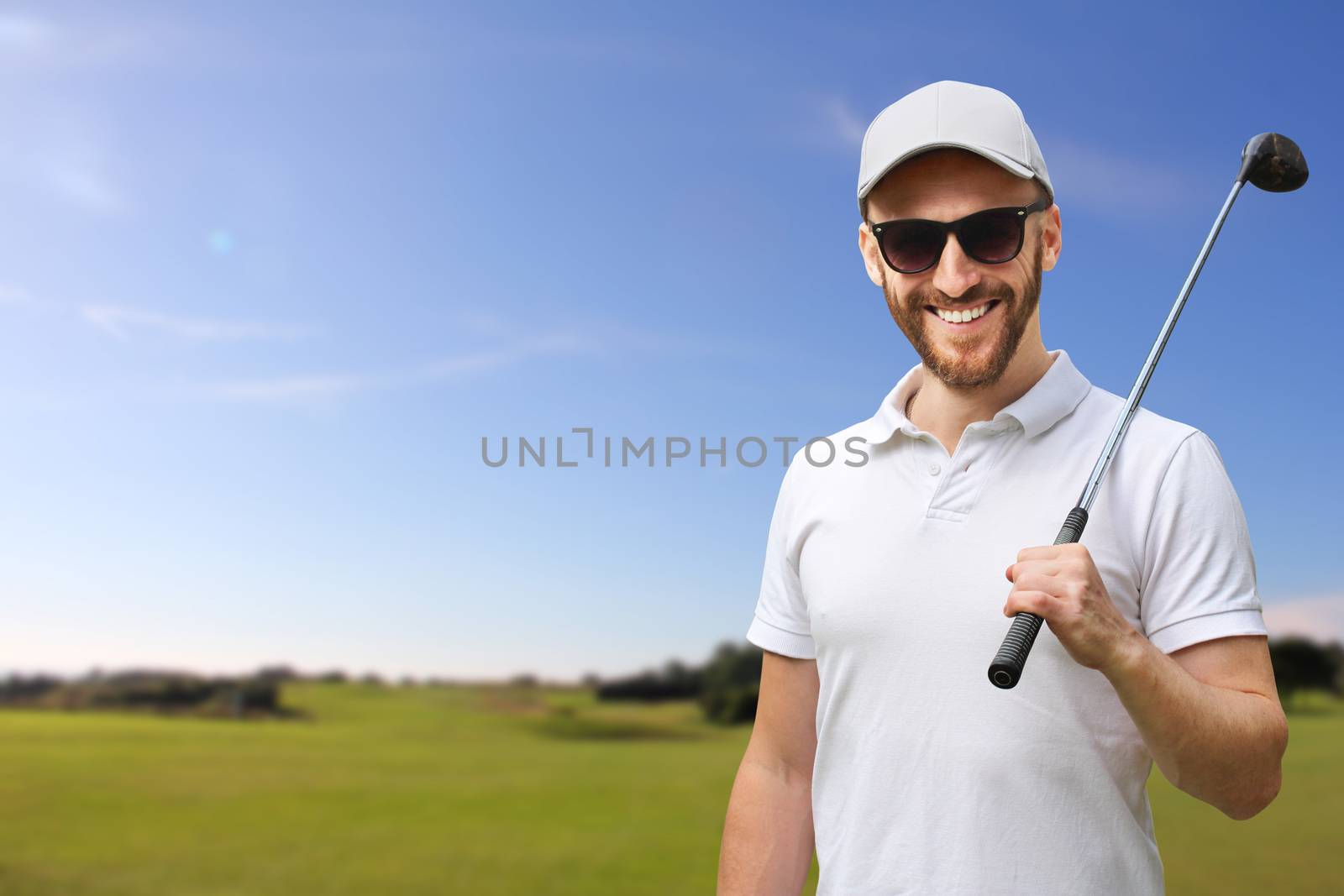 Portrait of male golfer with golf club at course