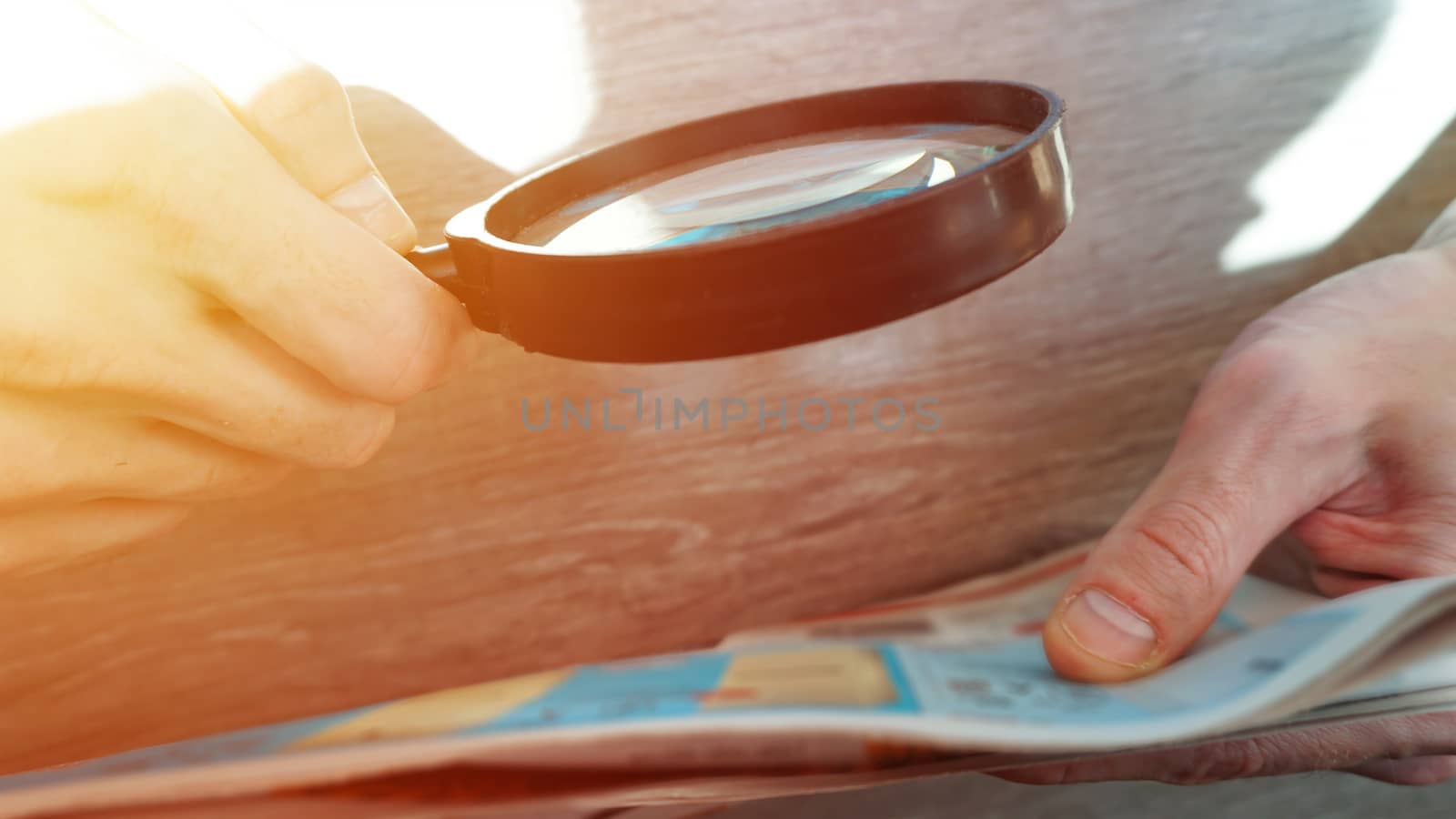 Businessman hand document and magnifier in office.