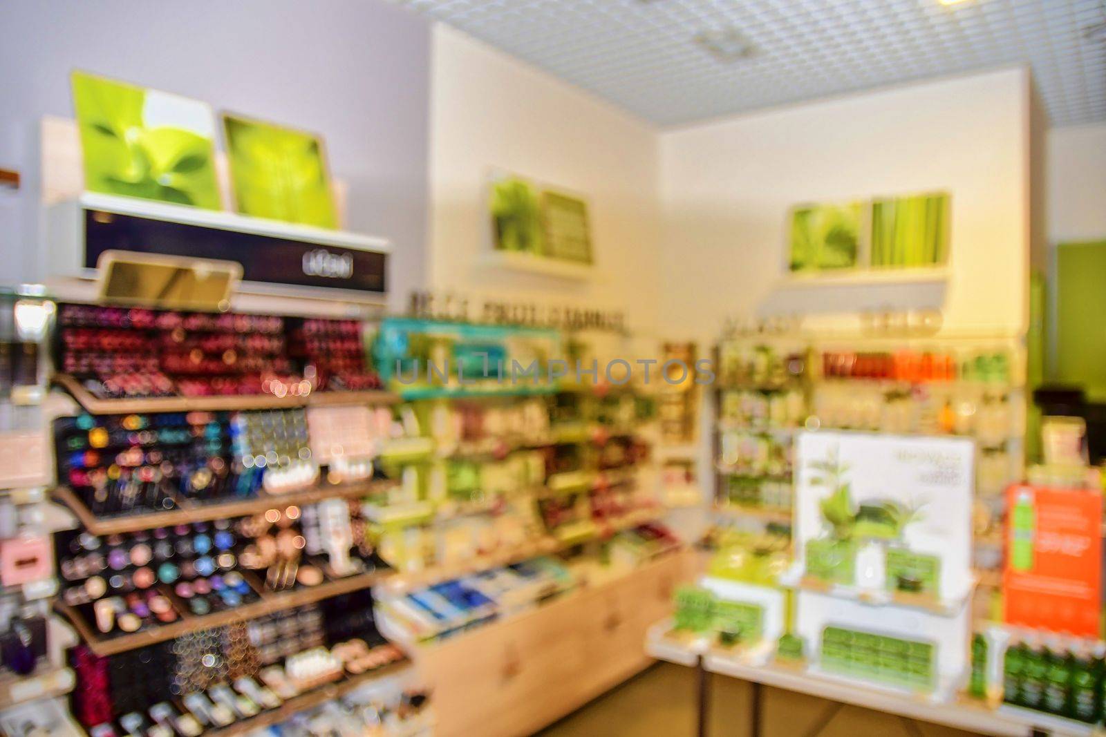 Blurred view on perfumery at retail store in Europe. Perfumery in local supermarket, defocused background.