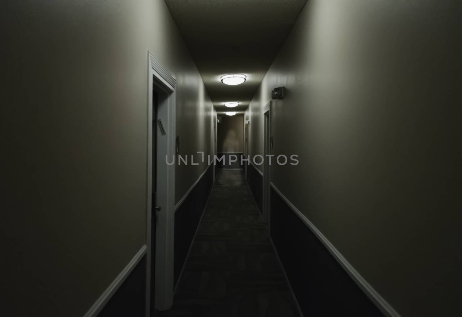 Artistic vision of a ghost of a woman standing in a hallway.