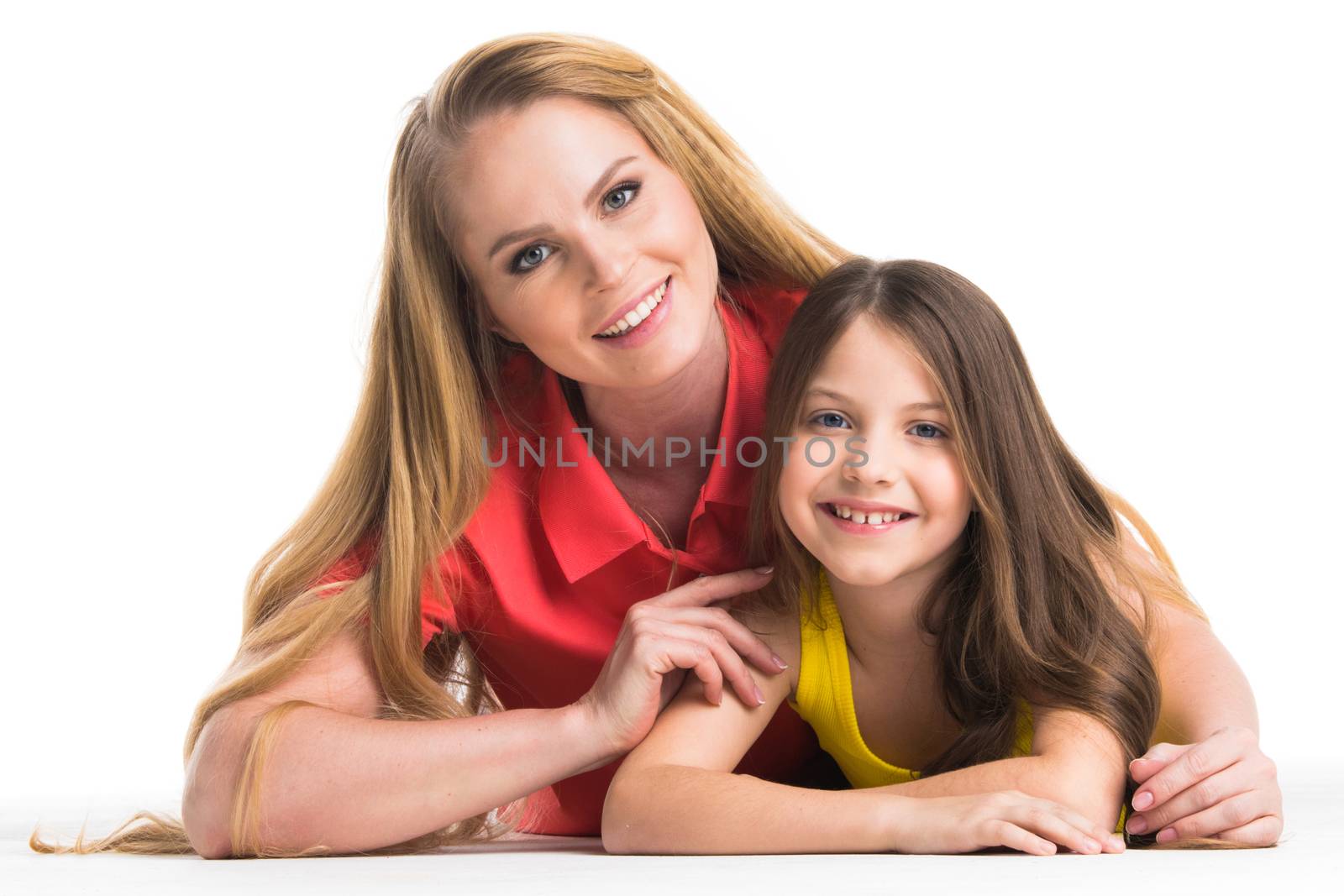Mother and daughter lying on the floor, isolated on white background