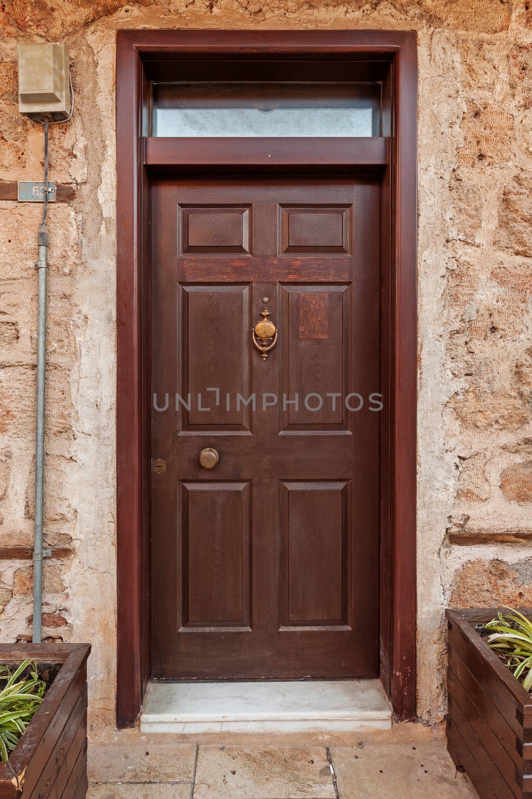 Old vintage grunge wooden door in rustic stone wall