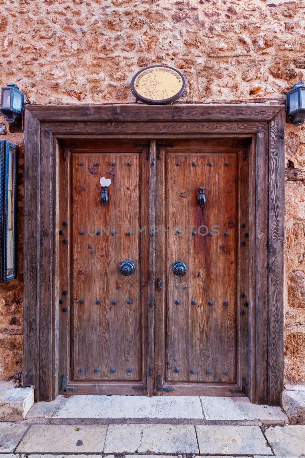 Old grunge wooden door with two hanging lights on both sides