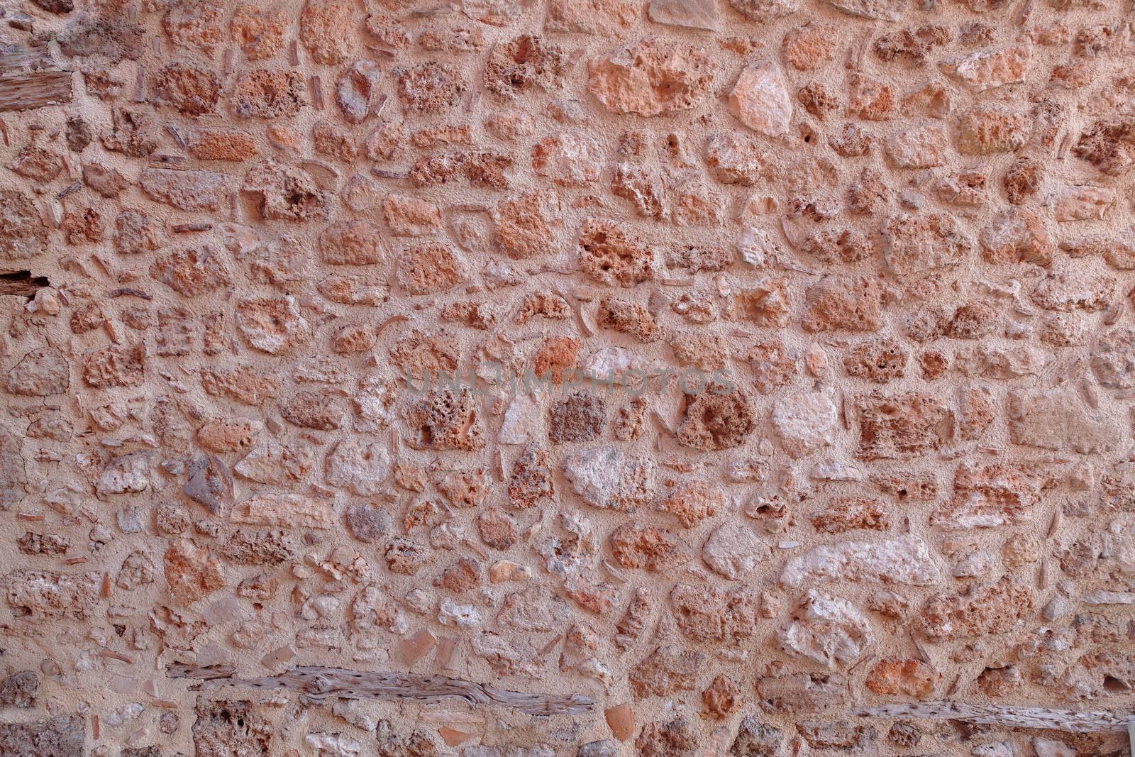 Background of stone fence wall of sandstone bricks