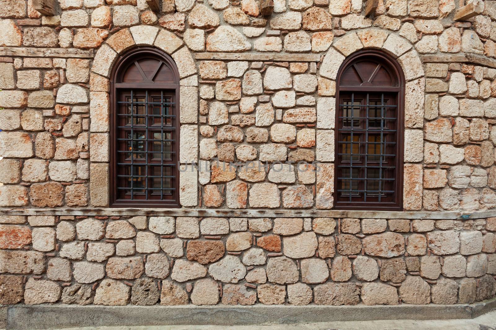 Ancient stone wall with wooden window in Turkey
