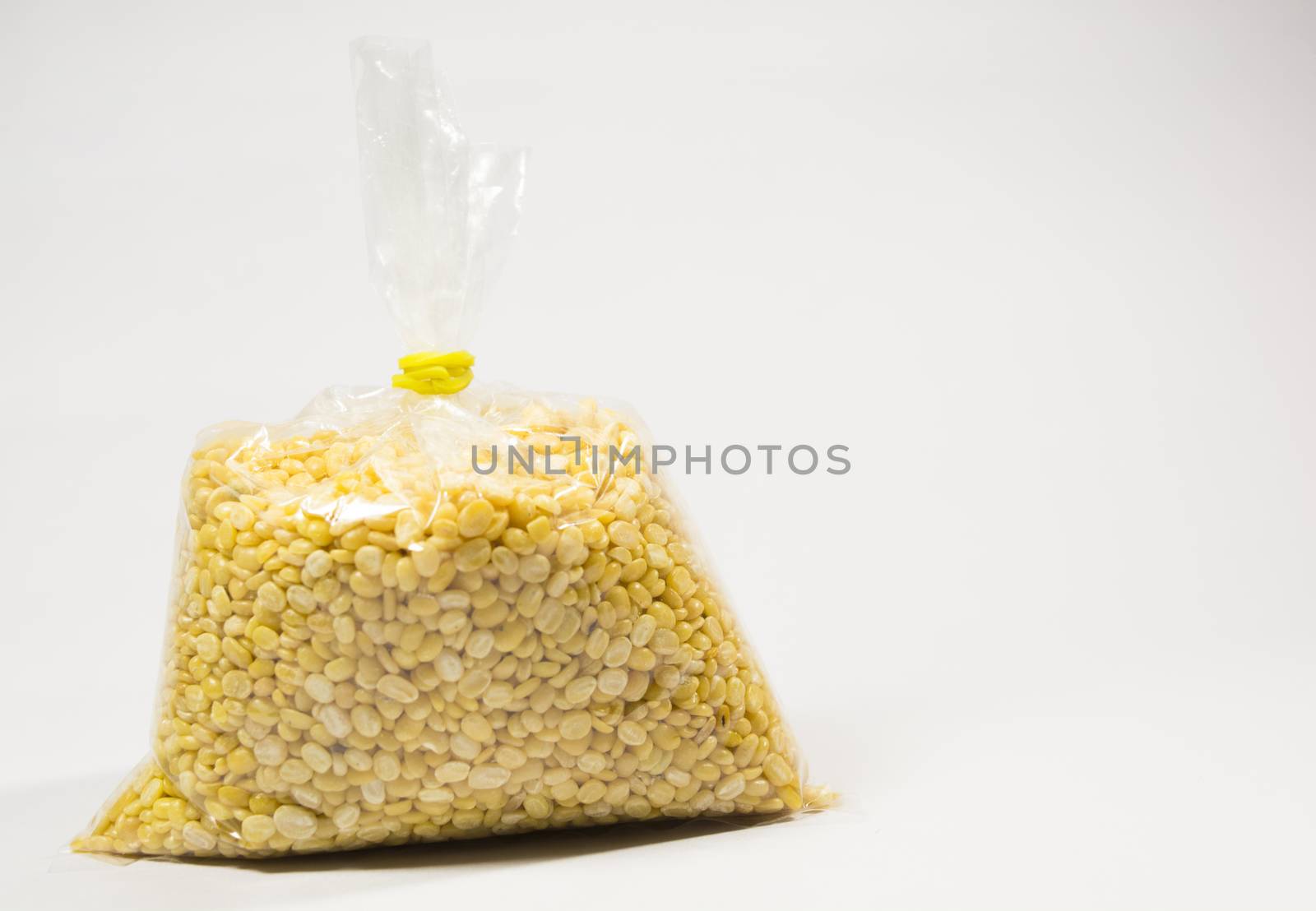 Split black grma seeds in white transperant bag on isolated white background