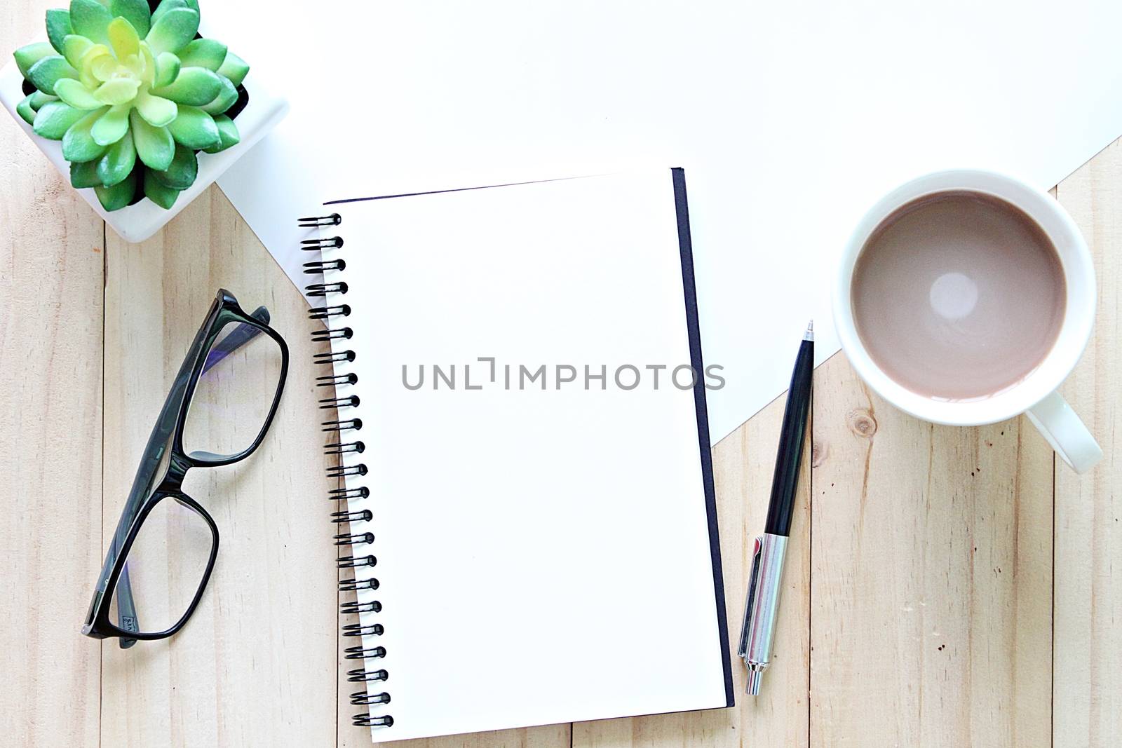 Still life, business, office supplies, planning or education concept : Top view or flat lay of open notebook with blank pages and coffee cup on office table, ready for adding or mock up