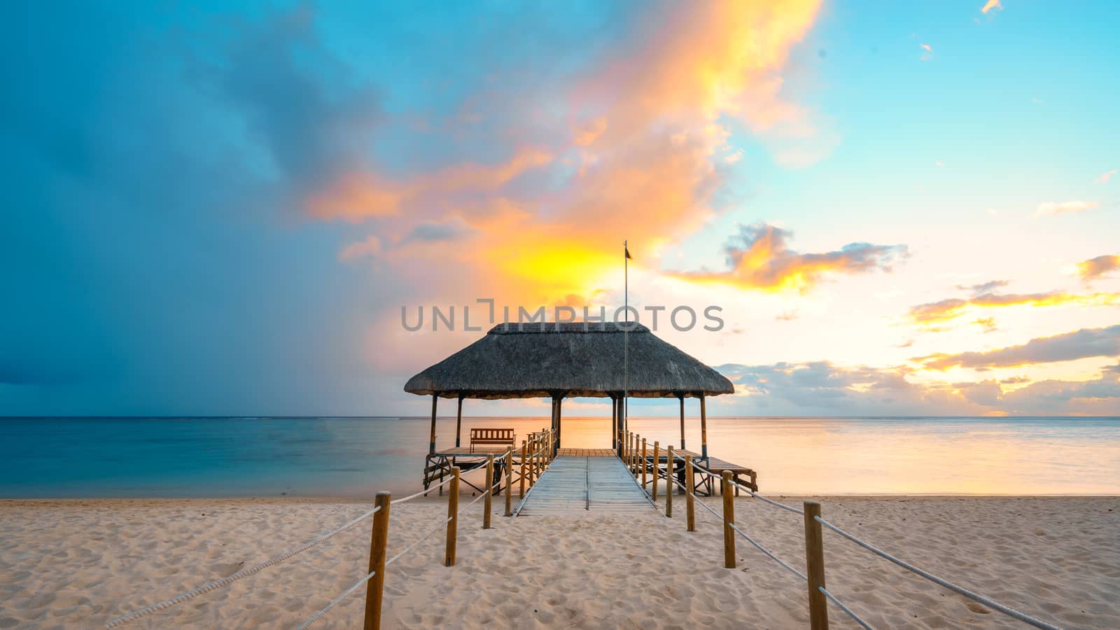 Amazing sunset in Mauritius Island (flic an flac beach) with Jetty silhouette.