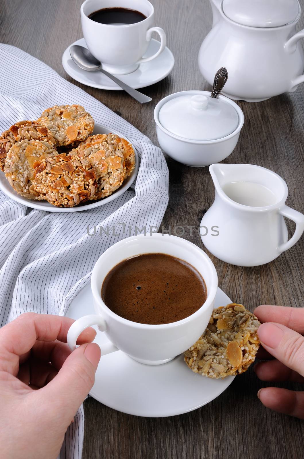 A cup of coffee with gluten-free cookies from cereals on the coffee table. It's time have a bite