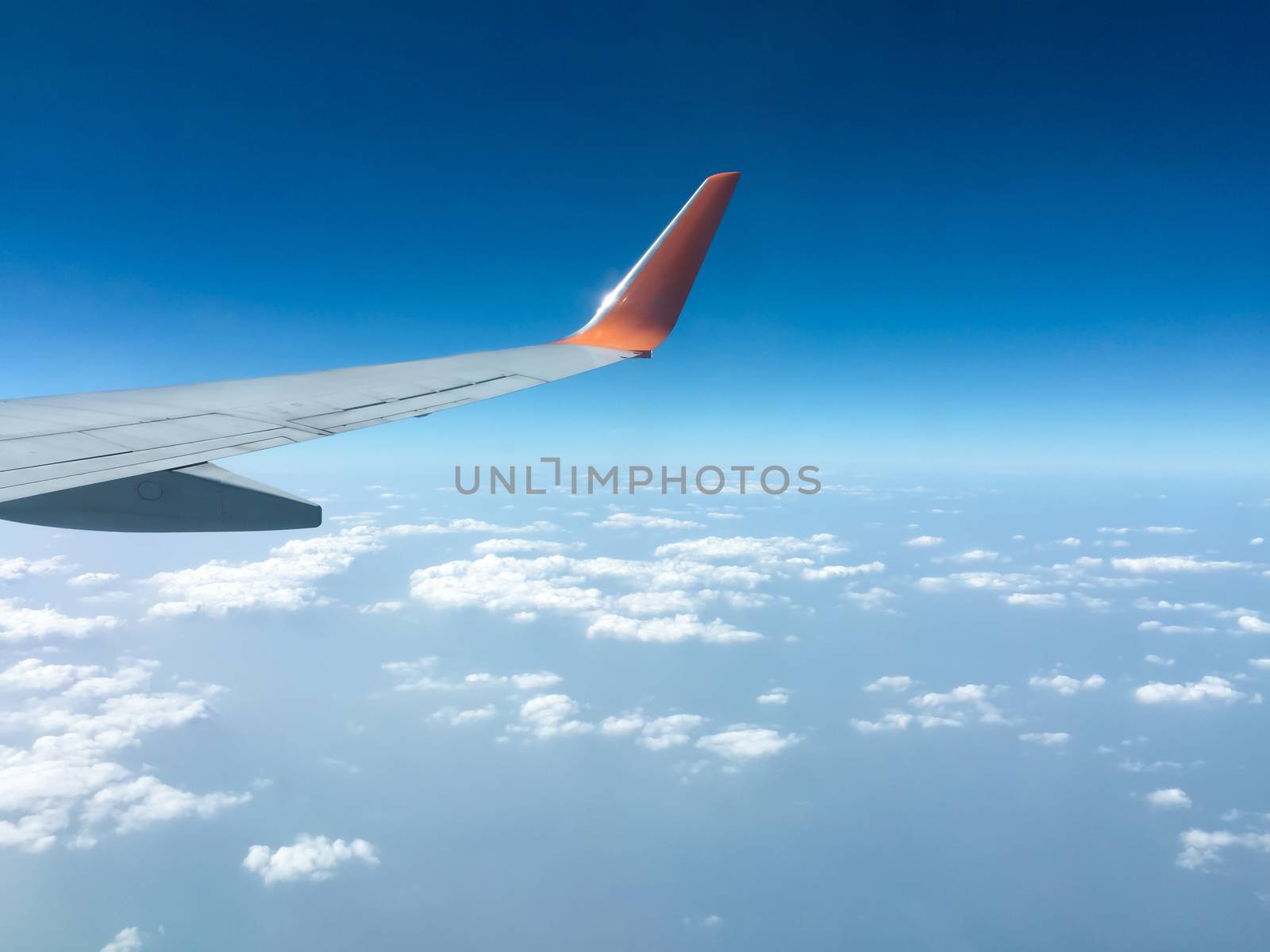 Top view sky and clouds looking from window airplane flying, nature background concept