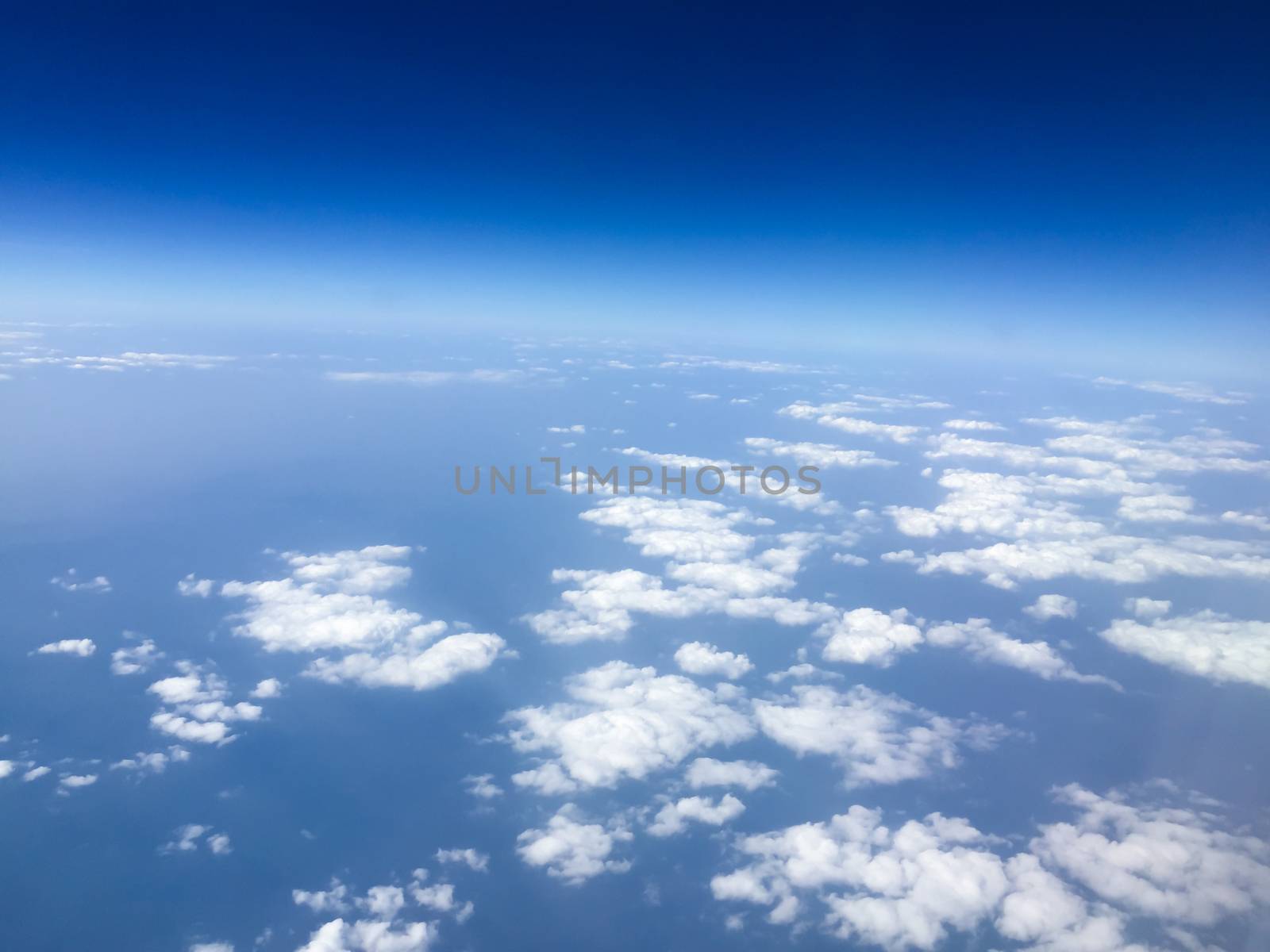 Top view sky and clouds looking from window airplane, nature background concept