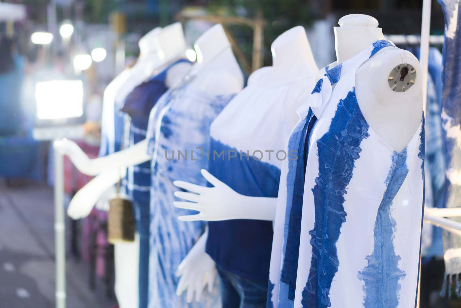 Closeup woman clothes blue color with mannequin at walking street, selective focus