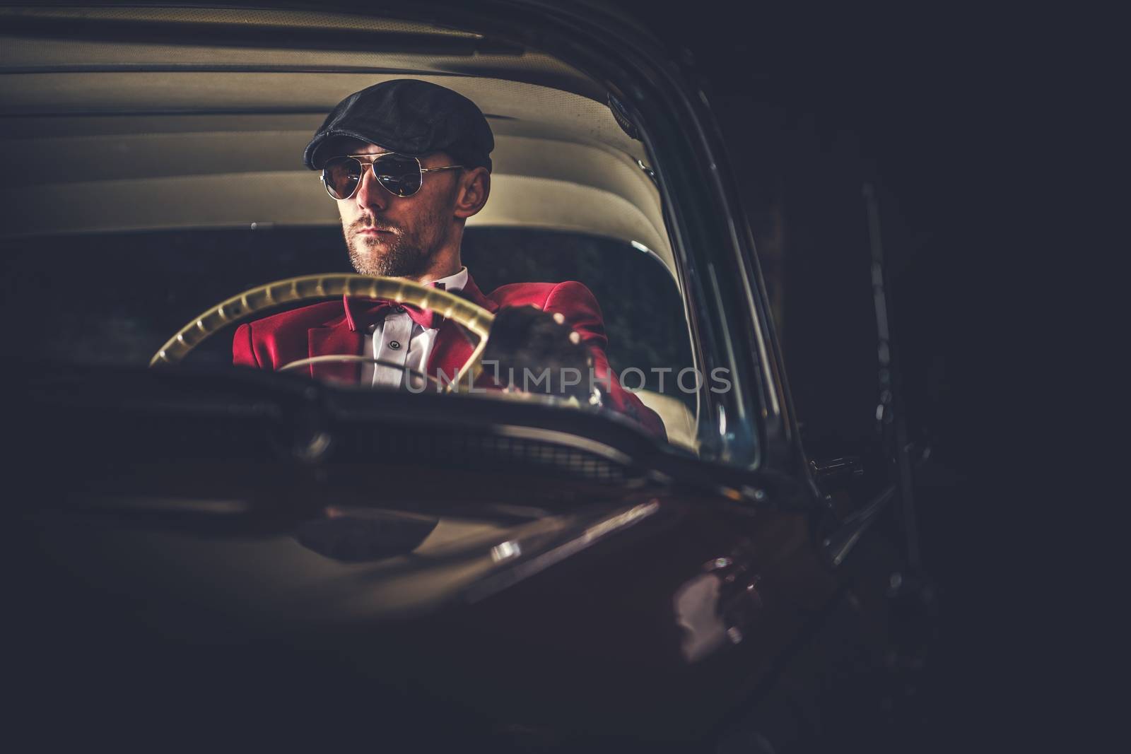 Elegant Caucasian Vintage Car Driver in Sunglasses. Passionate Driving His Classic Car.