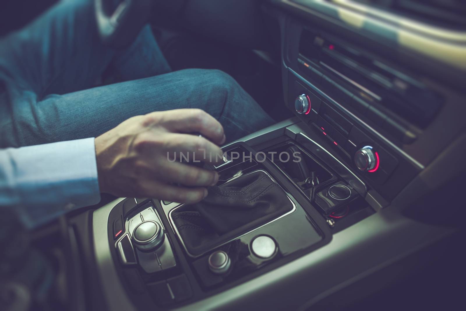 Caucasian Men Driving the Car. Shifting Automatic Transmission to Drive Position. 