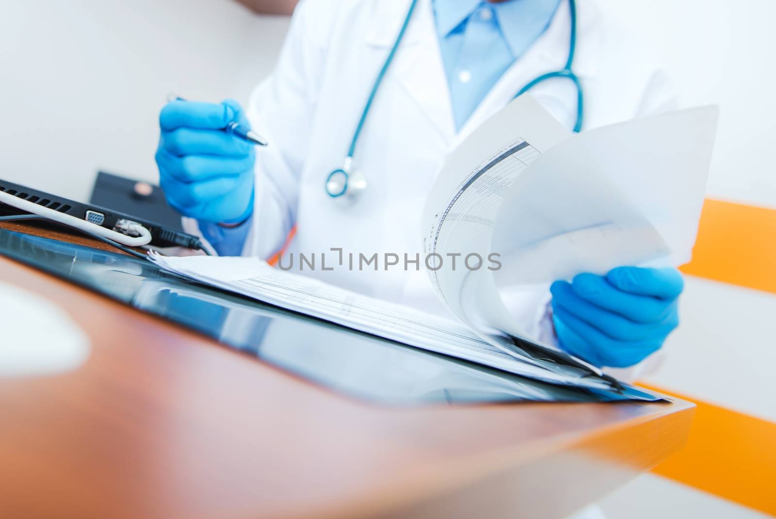 Medical Doctor Browsing Laboratory Data on His Desk. Healthcare Theme.