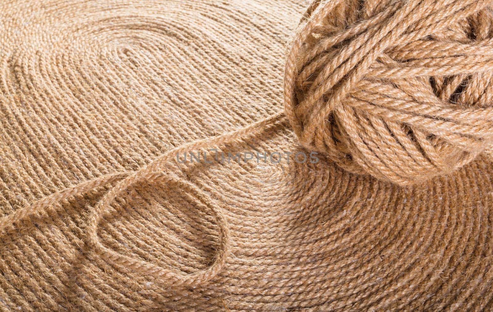 tangle of rope close-up on texture of handmade carpet