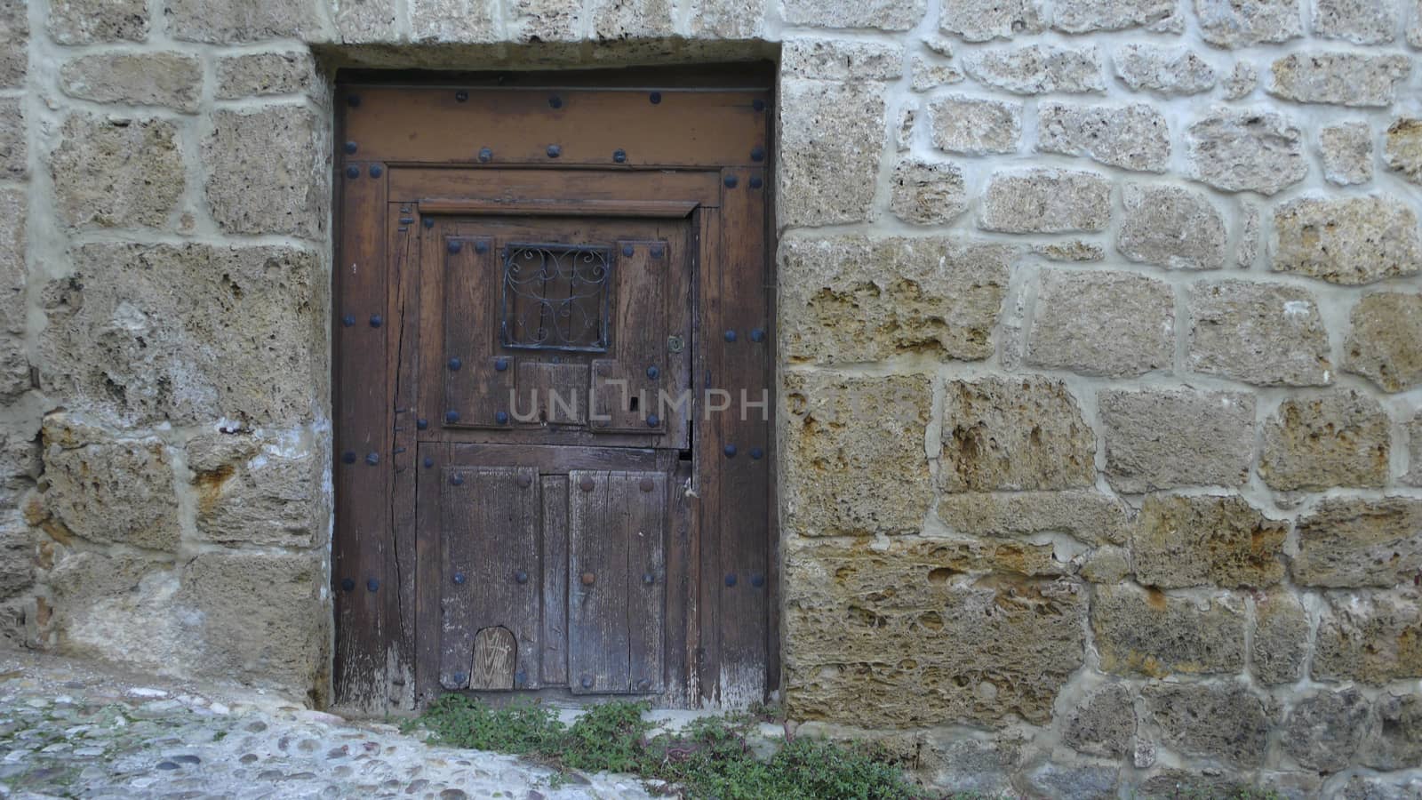 old wooden gate and stone wall