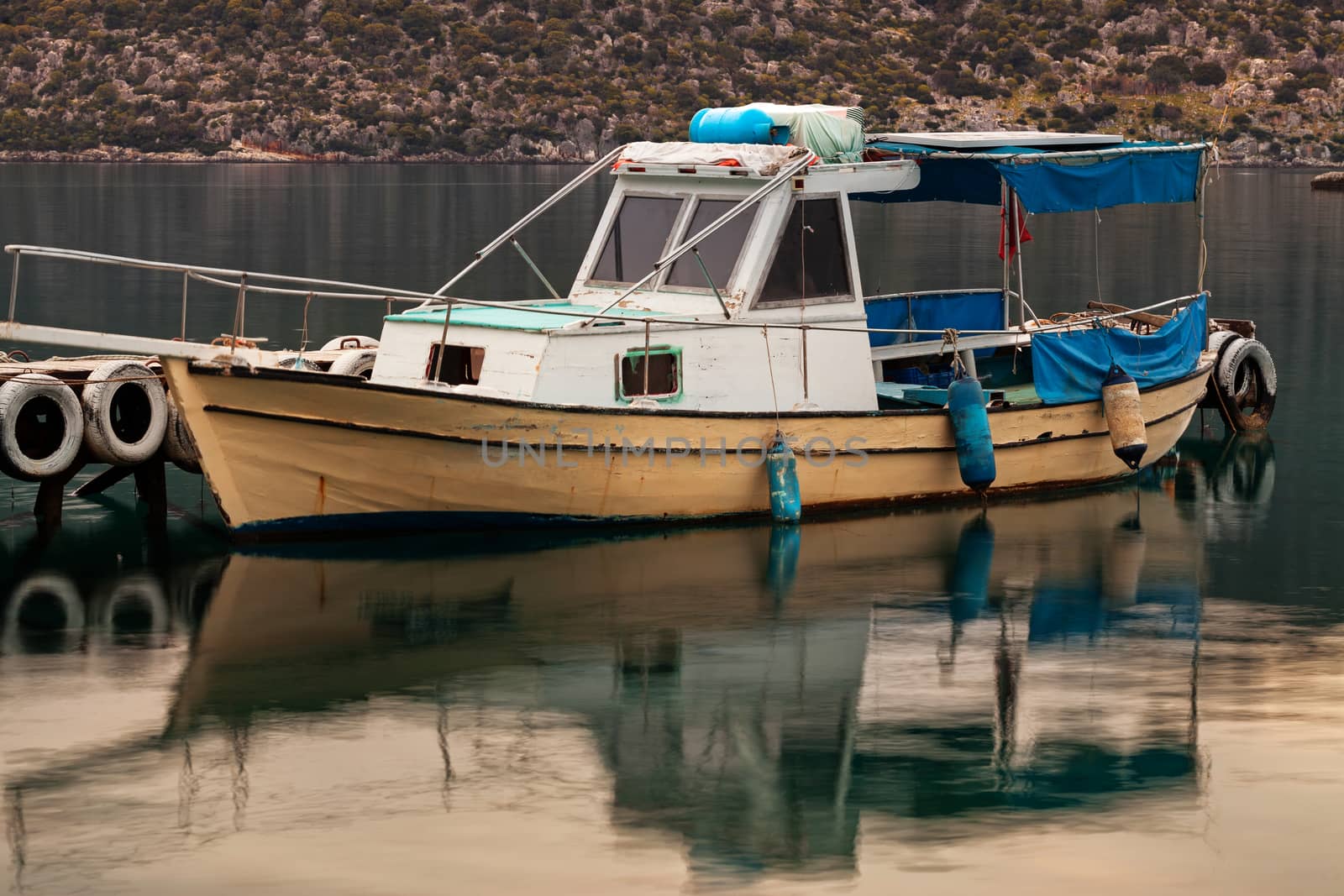 Boat docked in small fishers village Simena, near Kekova on Mediterranean Sea in Turkey