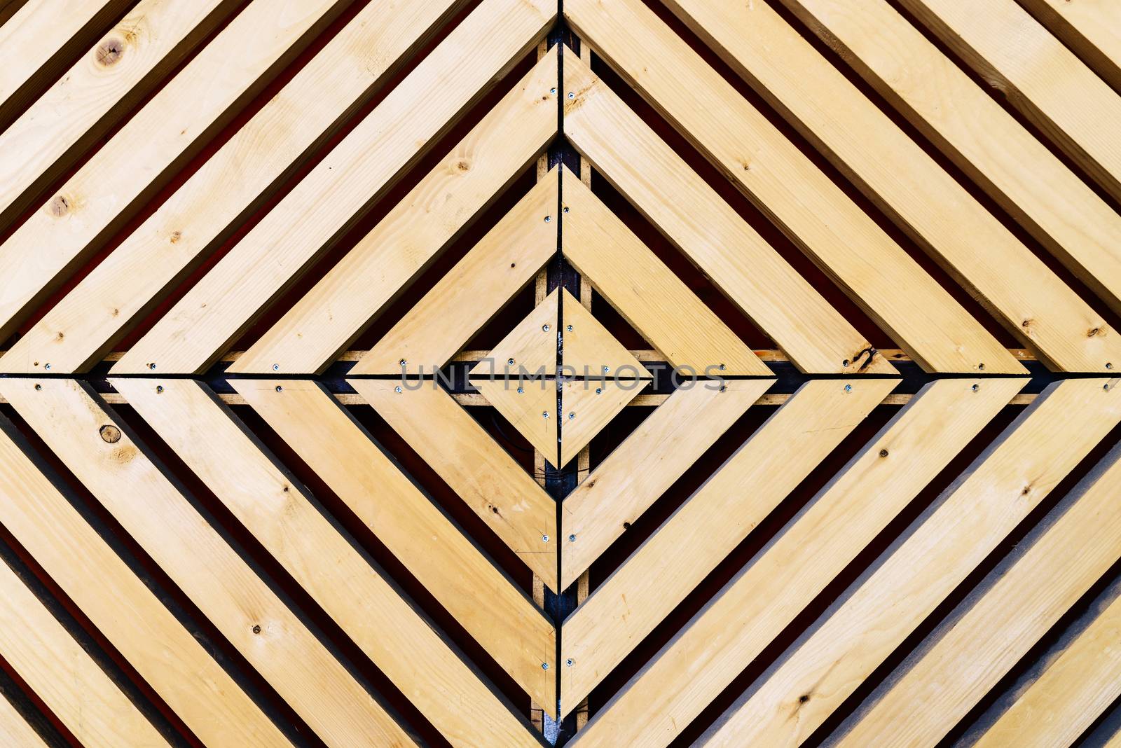Symmetrical diamond background pattern with natural wood in concentric squares or rectangles viewed from above
