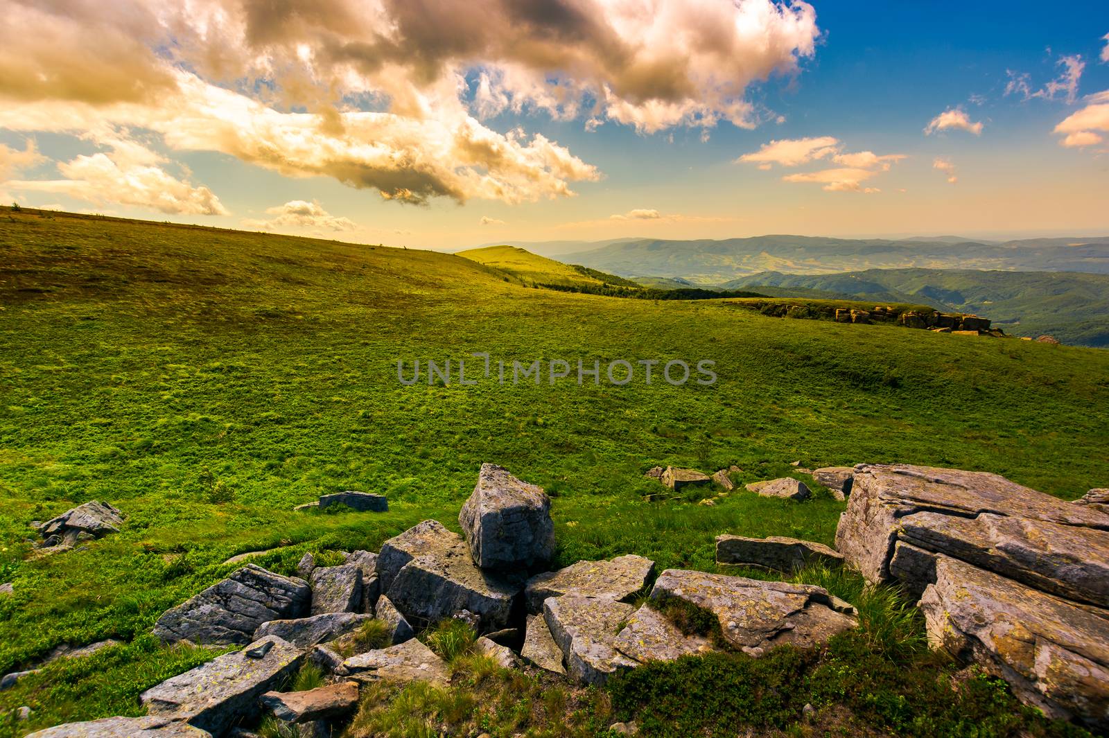 boulder on the grassy hillside at sunset by Pellinni