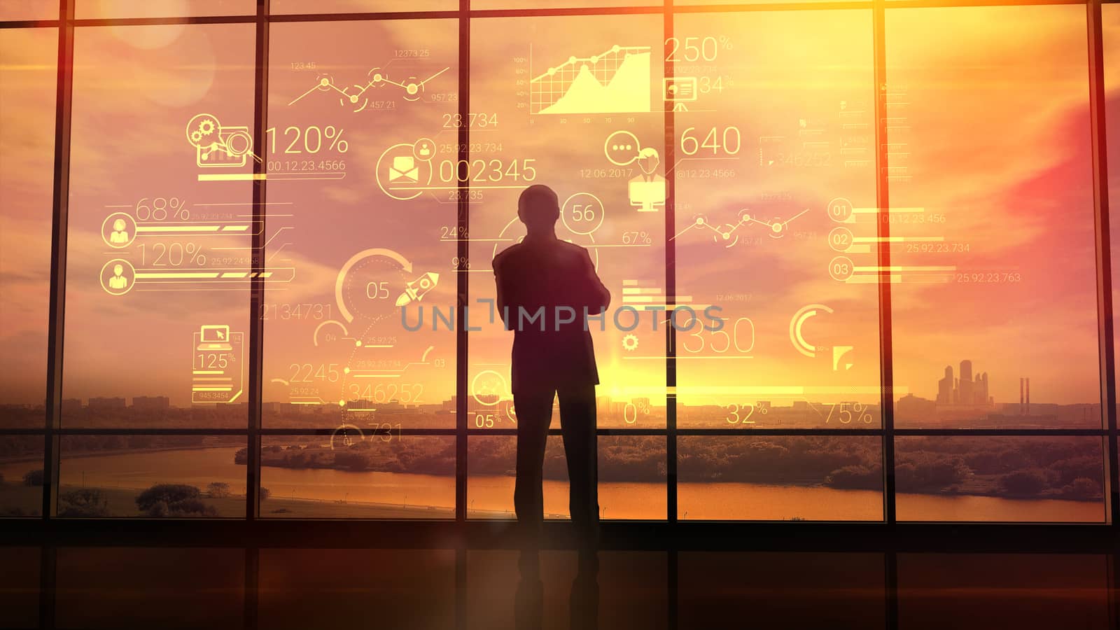 Silhouette of a man in a huge office in front of large windows viewing corporate infographics.