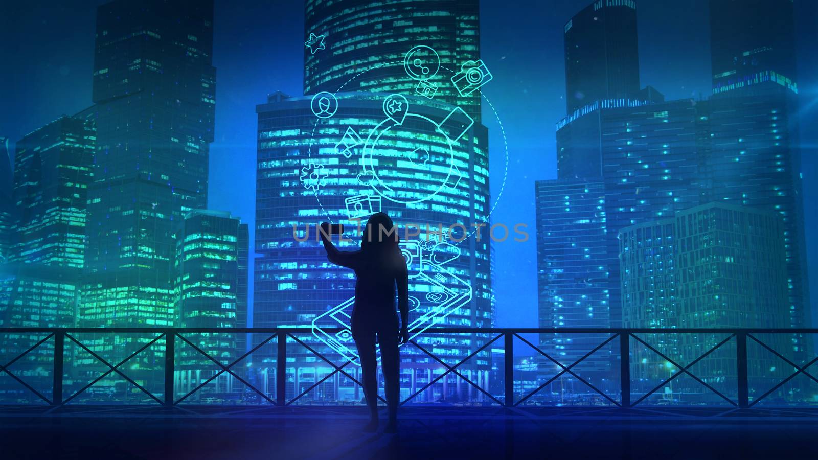 The girl makes selfie against the background of the skyscrapers of the modern evening city and infographics about social media.