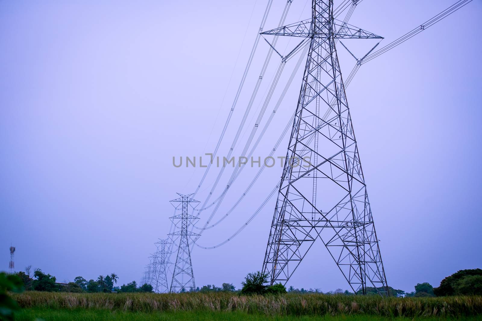 high voltage power lines during fiery sunset