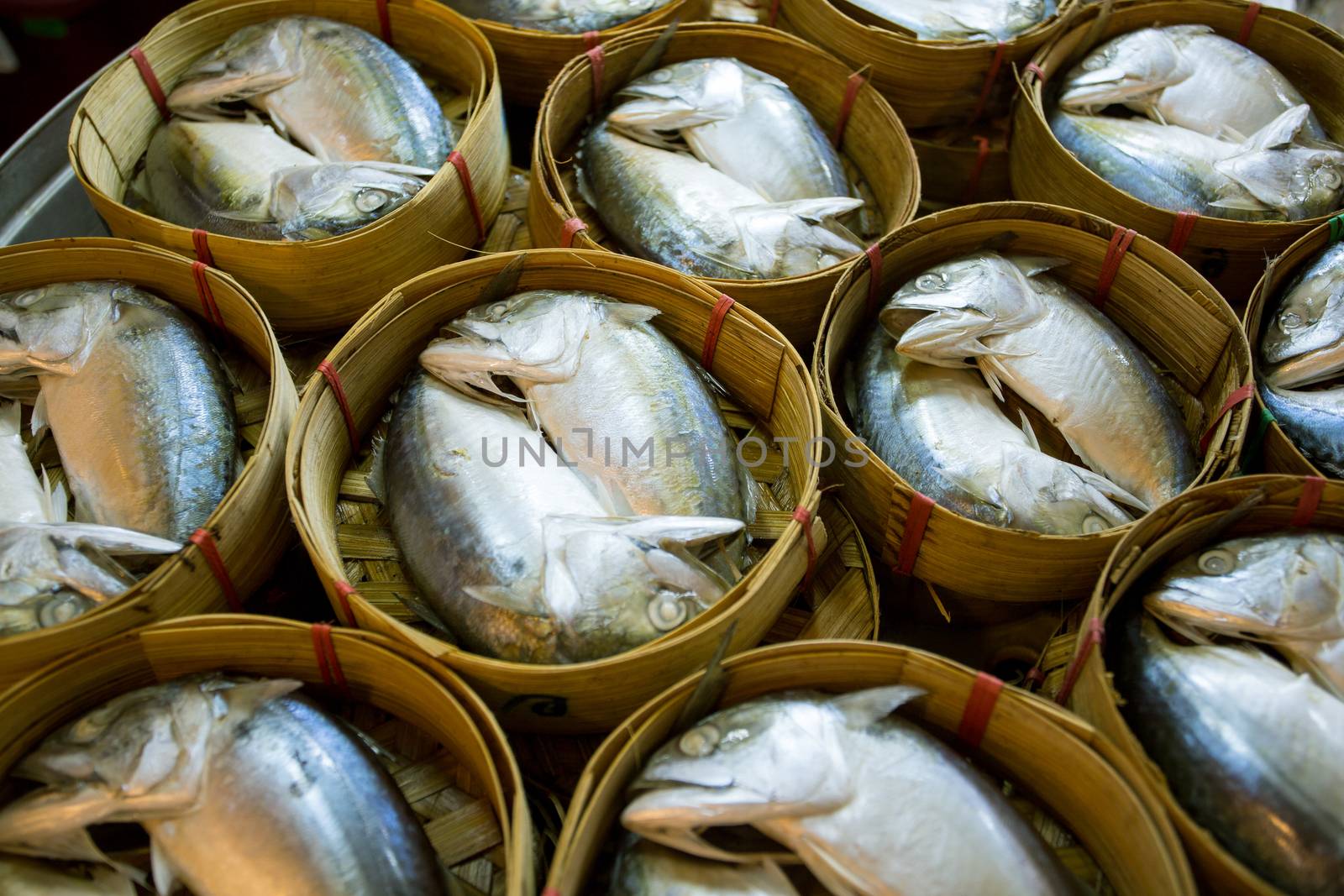 Baskets of mackerel fish in Thai street markets by antpkr