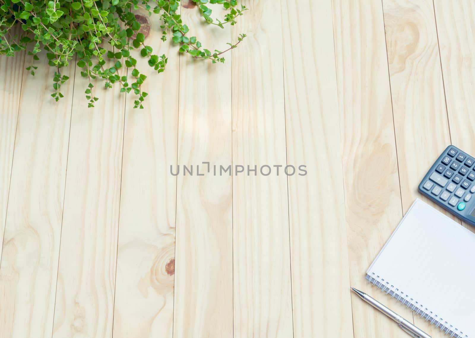 Top view of pen with calculator and notebook on wooden table and copy space for insert text.
