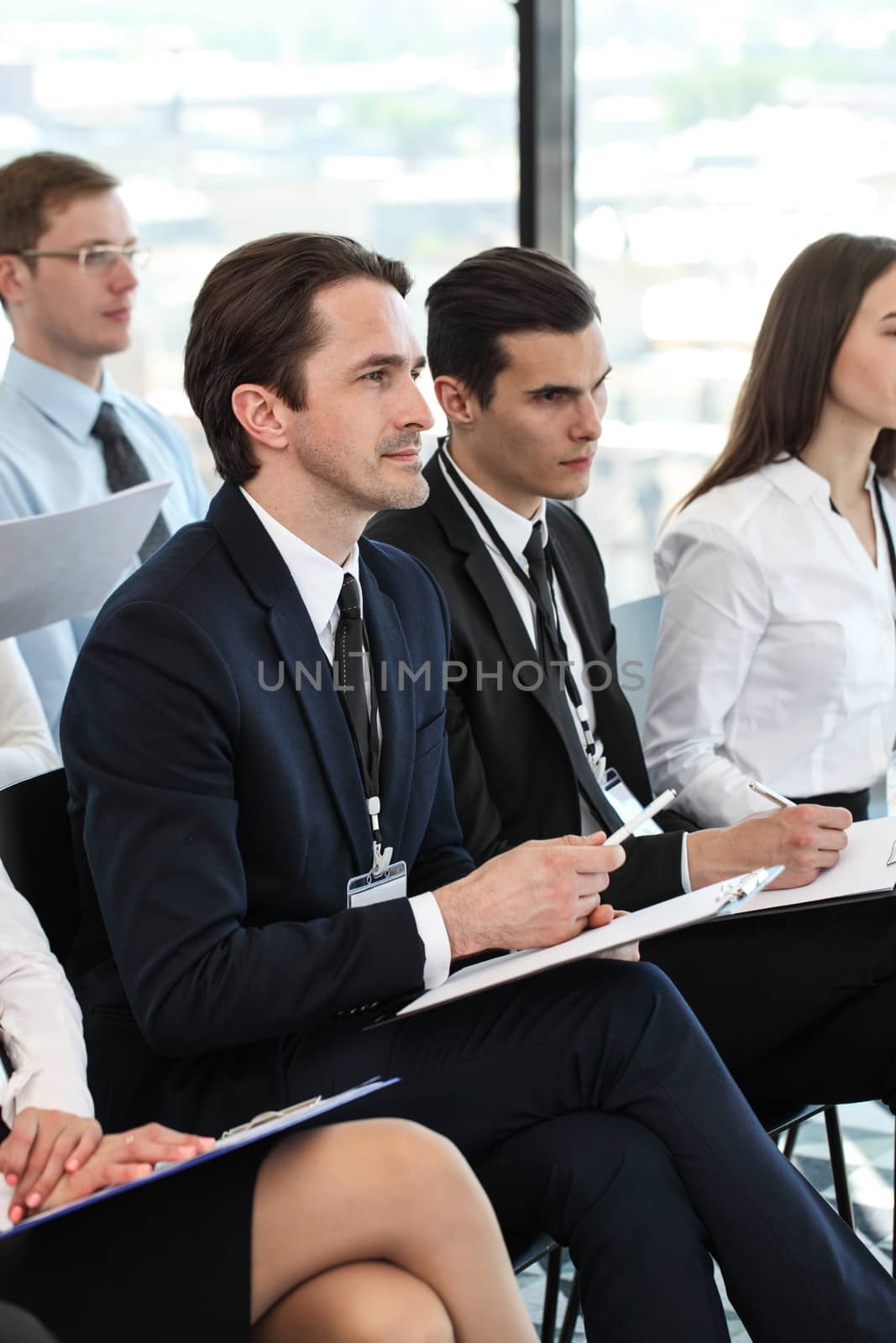 Audience of business people at conference or seminar