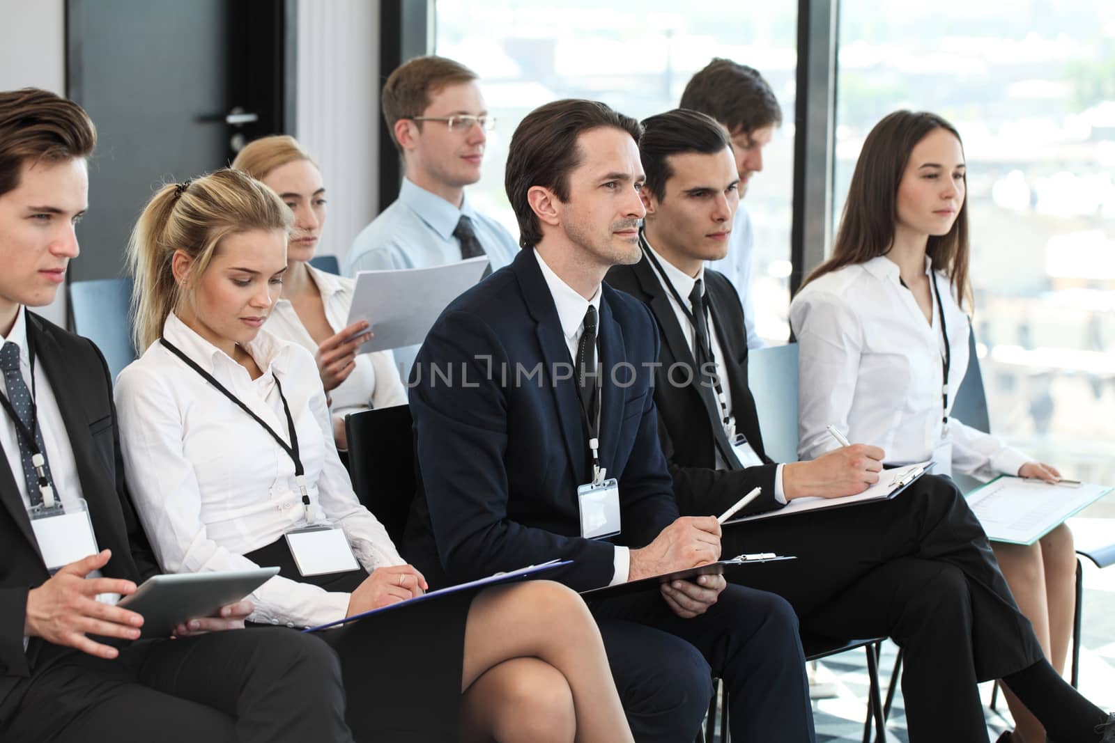 Audience of business people at conference or seminar