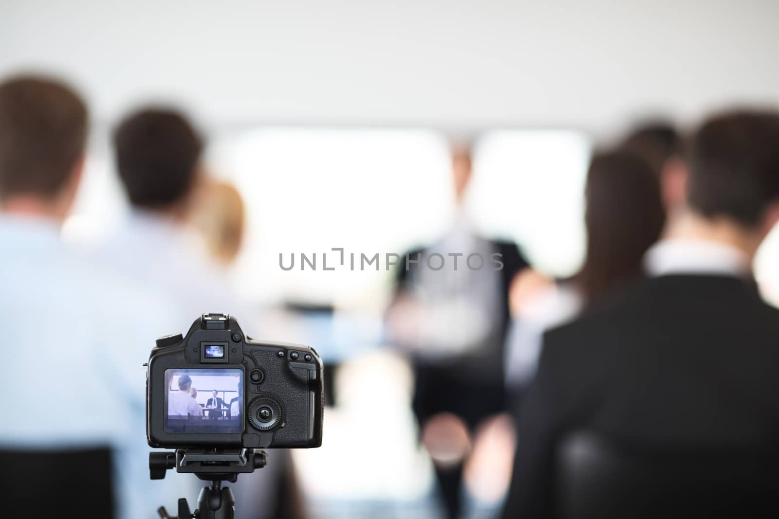 Making video of business people at meeting with photo camera