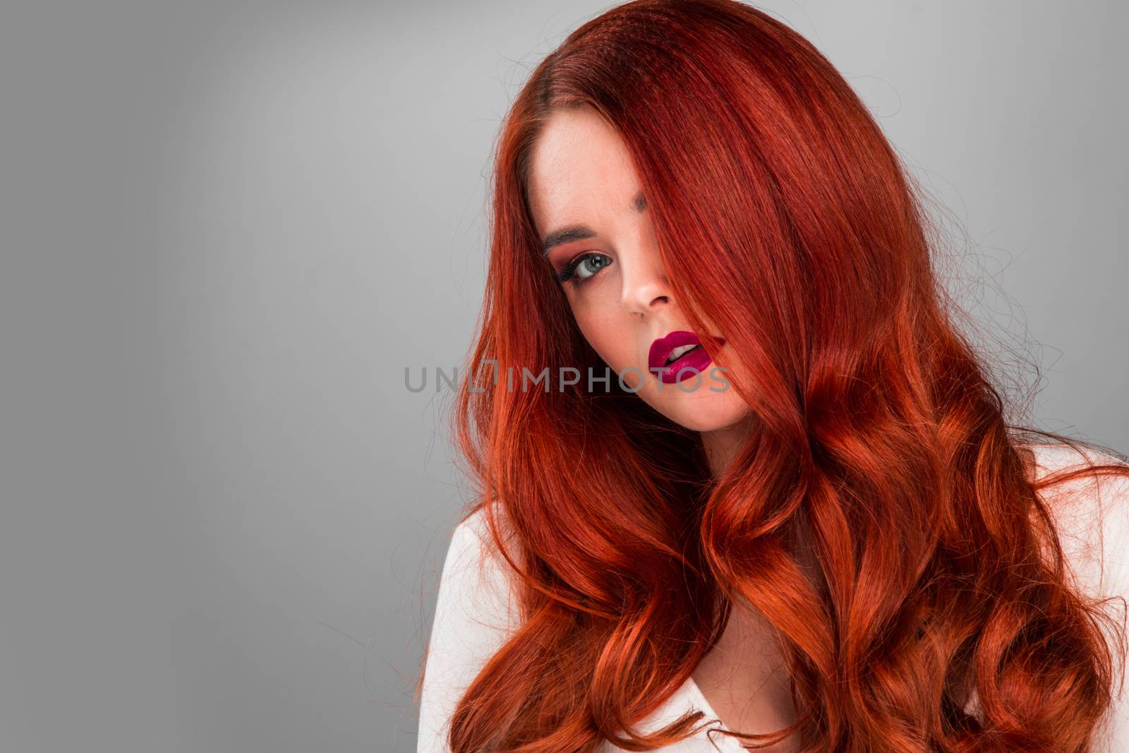 Beauty portrait of woman. Gorgeous sensual attractive pretty redhead sexy model girl, shiny wavy hair.