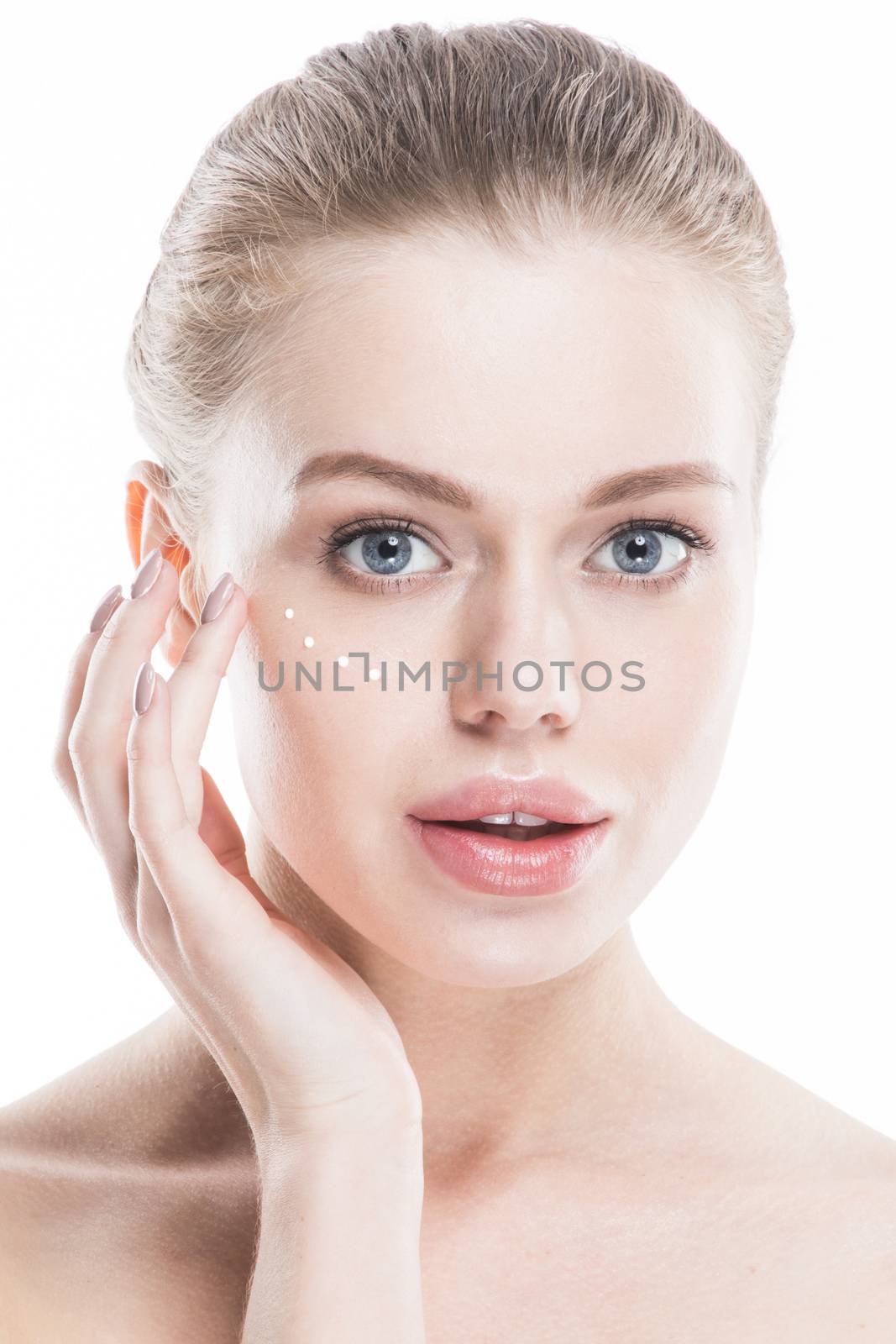 Beautiful woman with perfect skin applying cream, isolated on white background