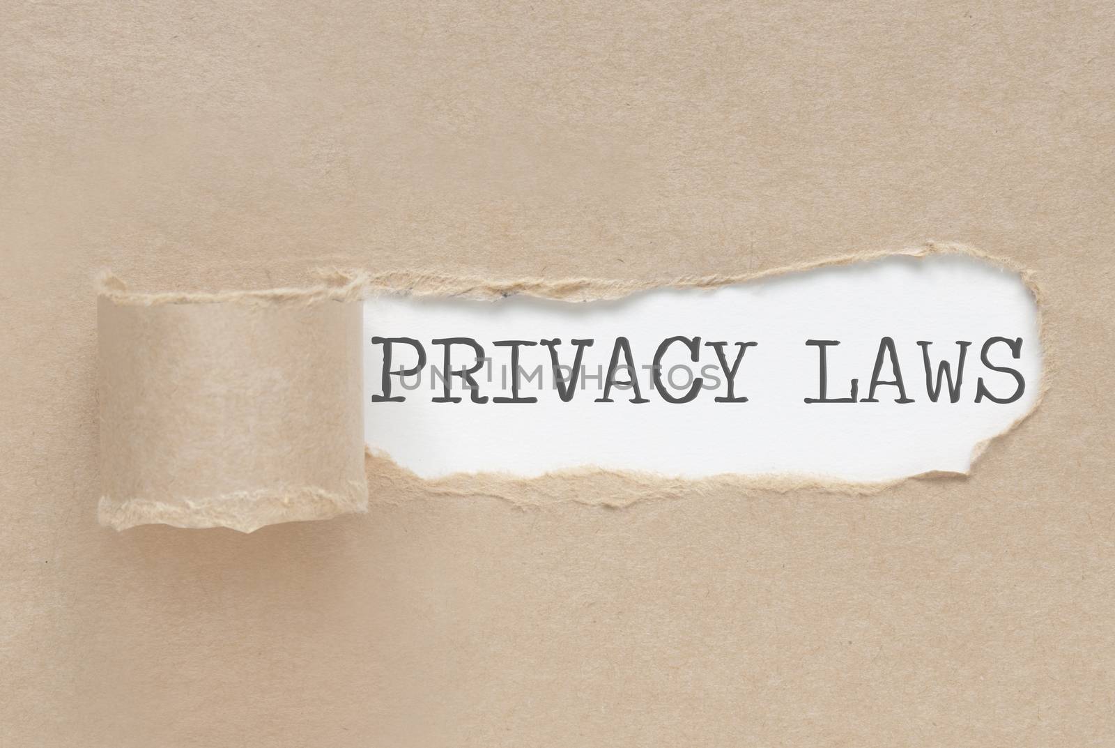 Torn paper revealing the words privacy laws