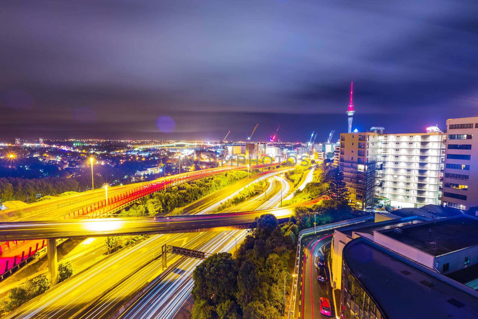 Long exposure shot of Auckland New Zealand transport at night with sky tower