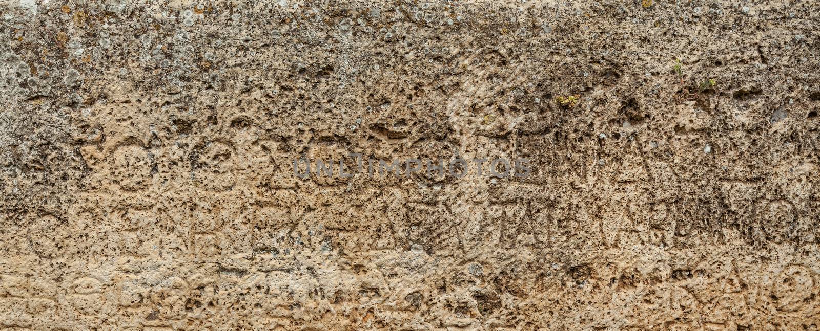 Texture of stone plate with inscriptions in ancient city Hierapolis near Pamukkale, Turkey