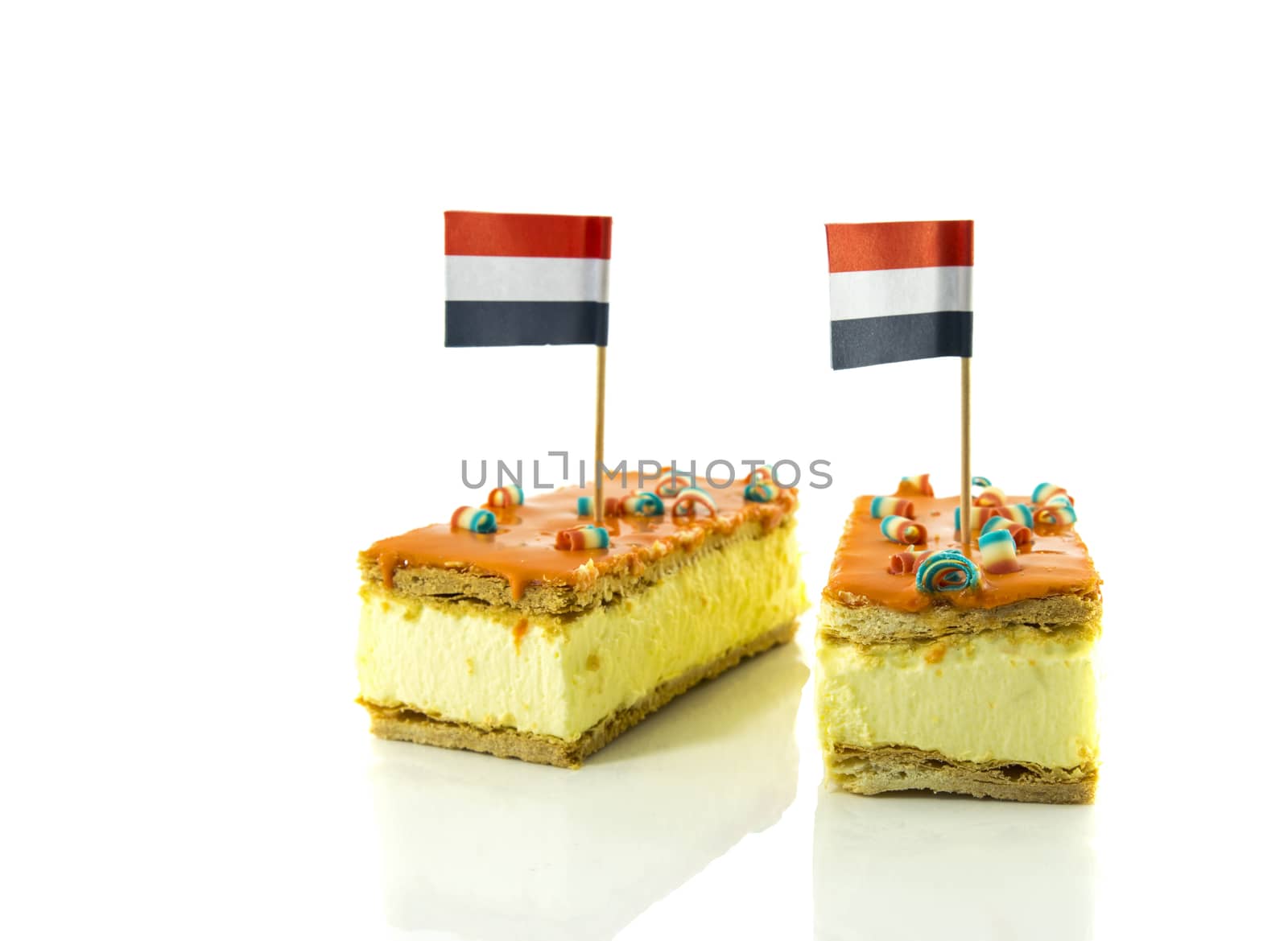 two orange tompouce, the traditional dutch pastry with the dutch flag , mostly on kingsday, therefore the color is orange, the dutch traditional color